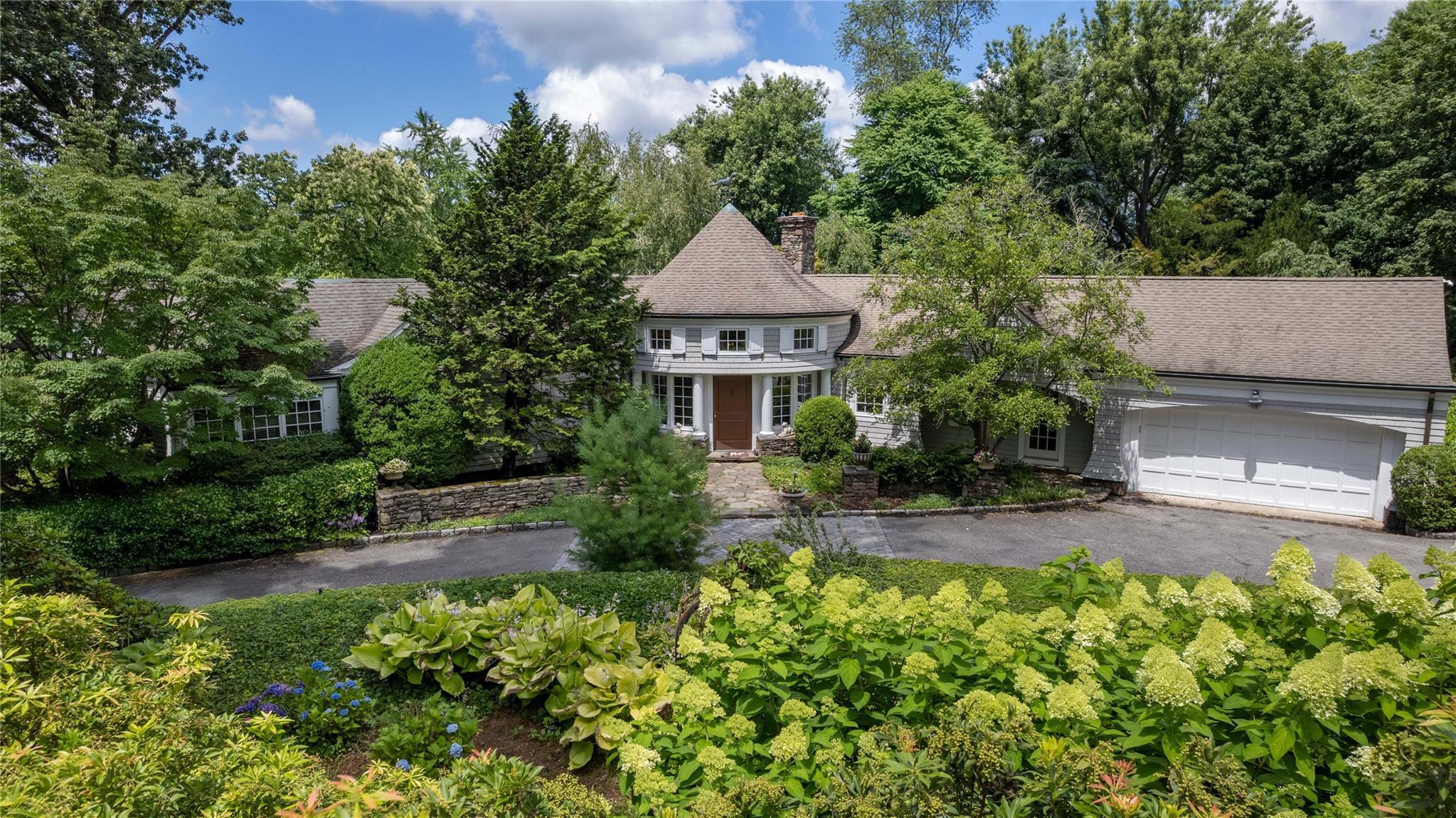 Set on over an acre of beautifully curated and private grounds, this e...