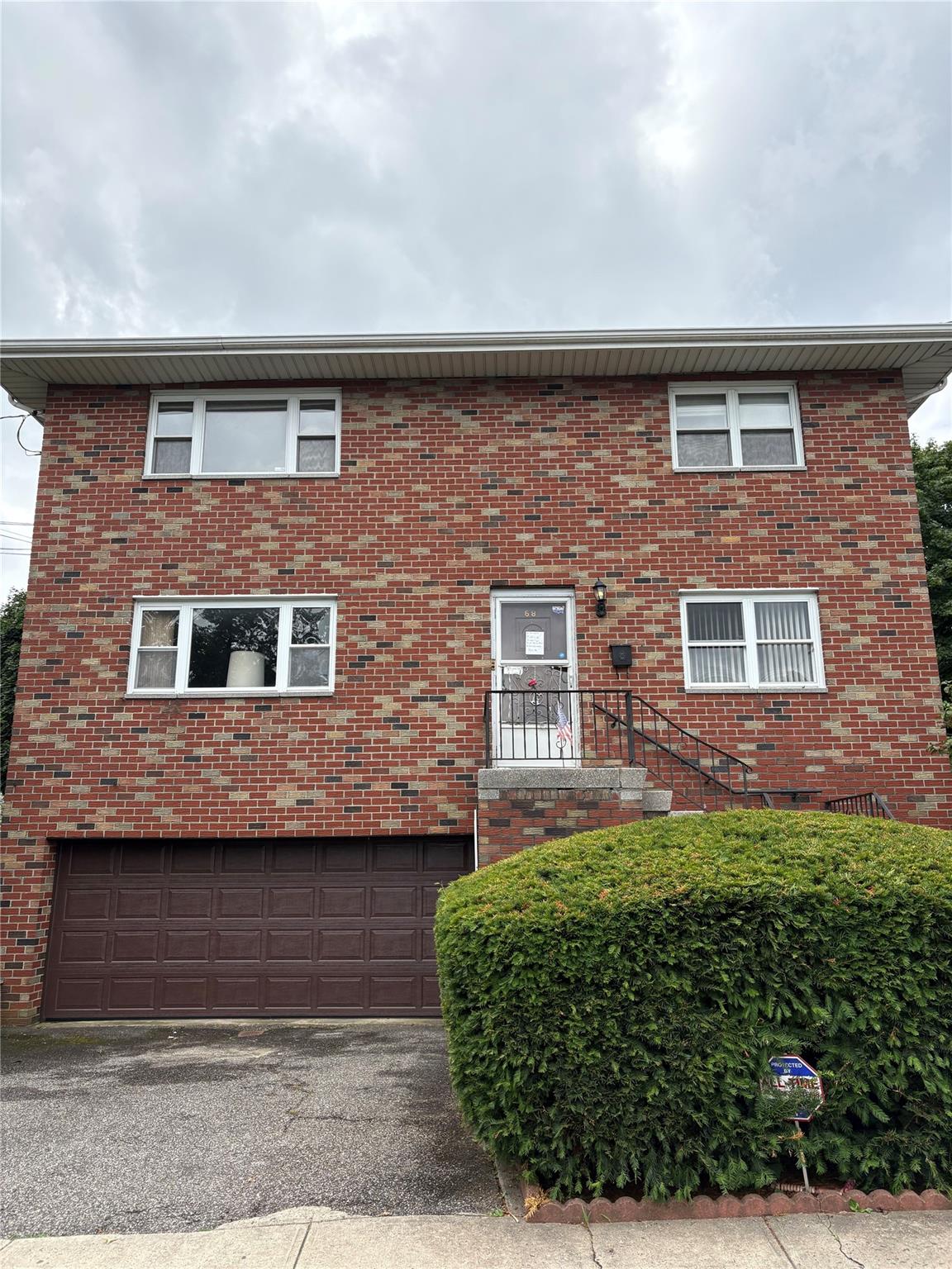 This beautiful brick Colonial is a legal two-family home with a finish...