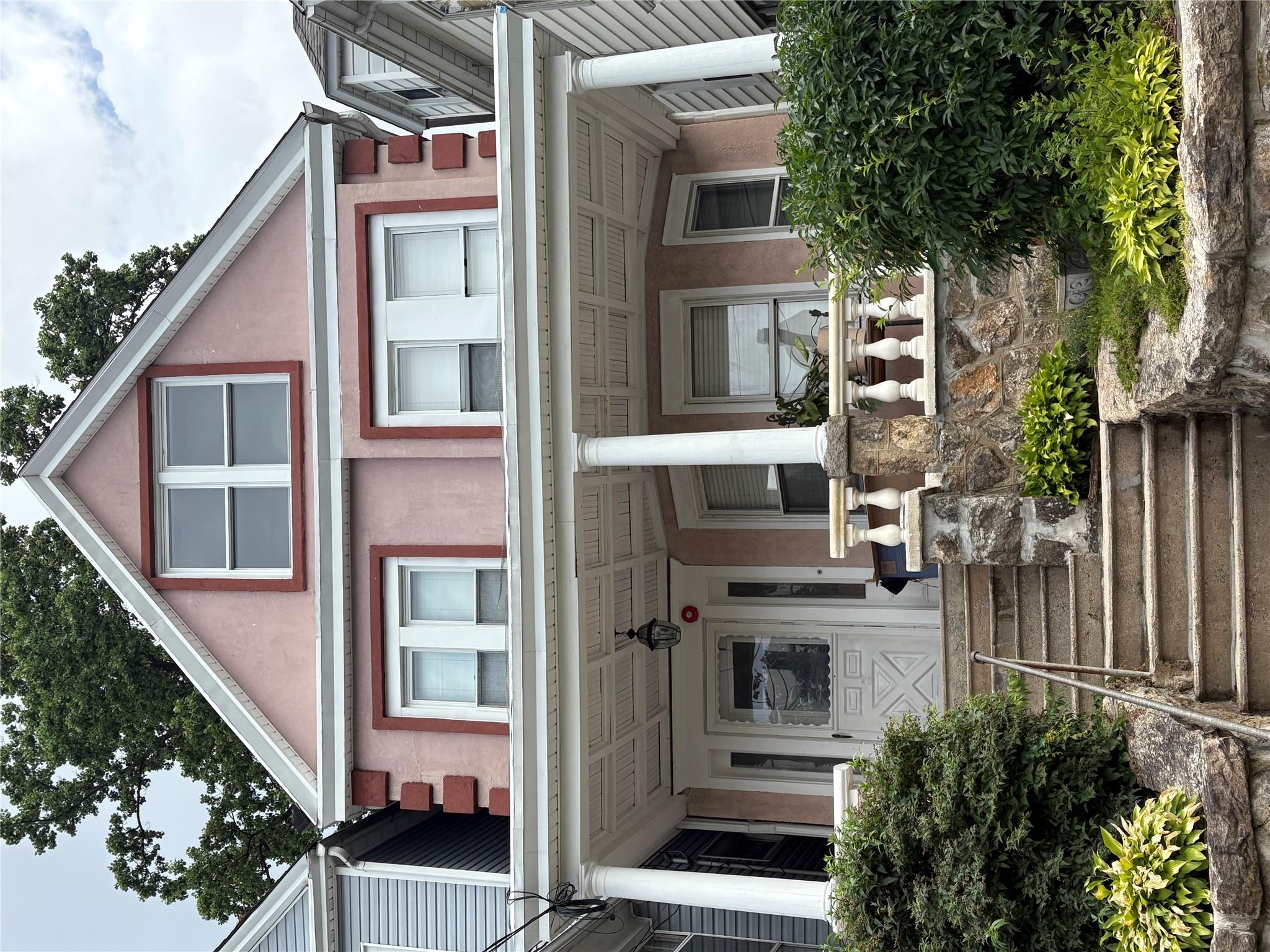 This single-family residence in East Yonkers features beautiful stucco...