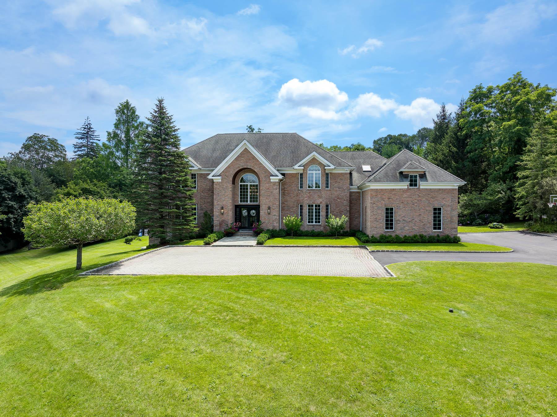 Nestled behind a gated entry on nearly three private acres in Armonk,...