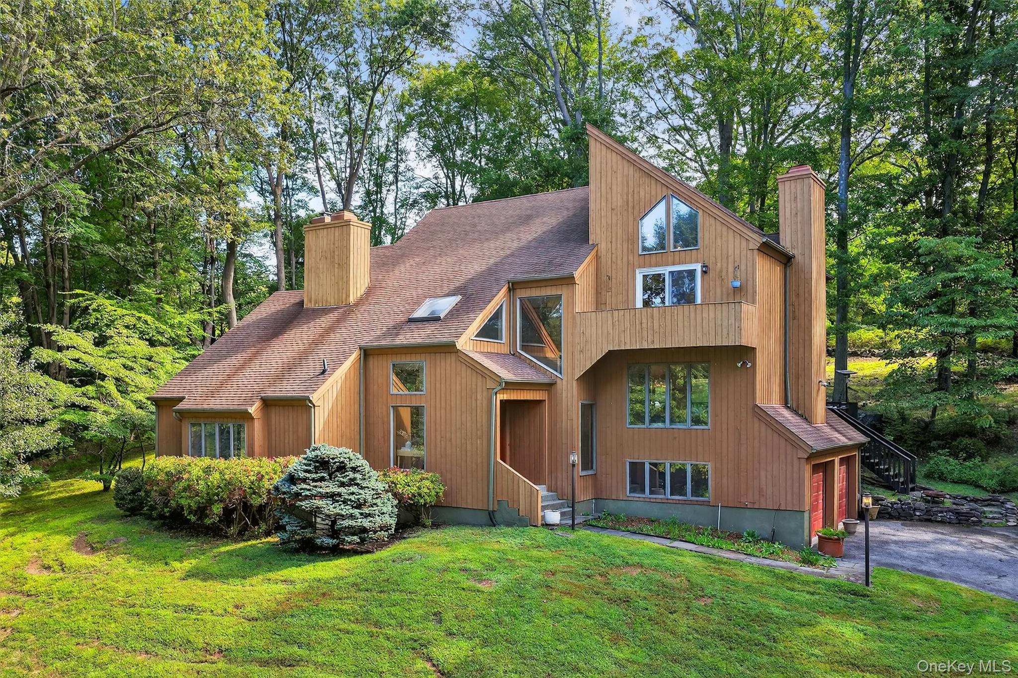 Nestled on nearly two acres of lush, tree-lined property, this sun-fil...