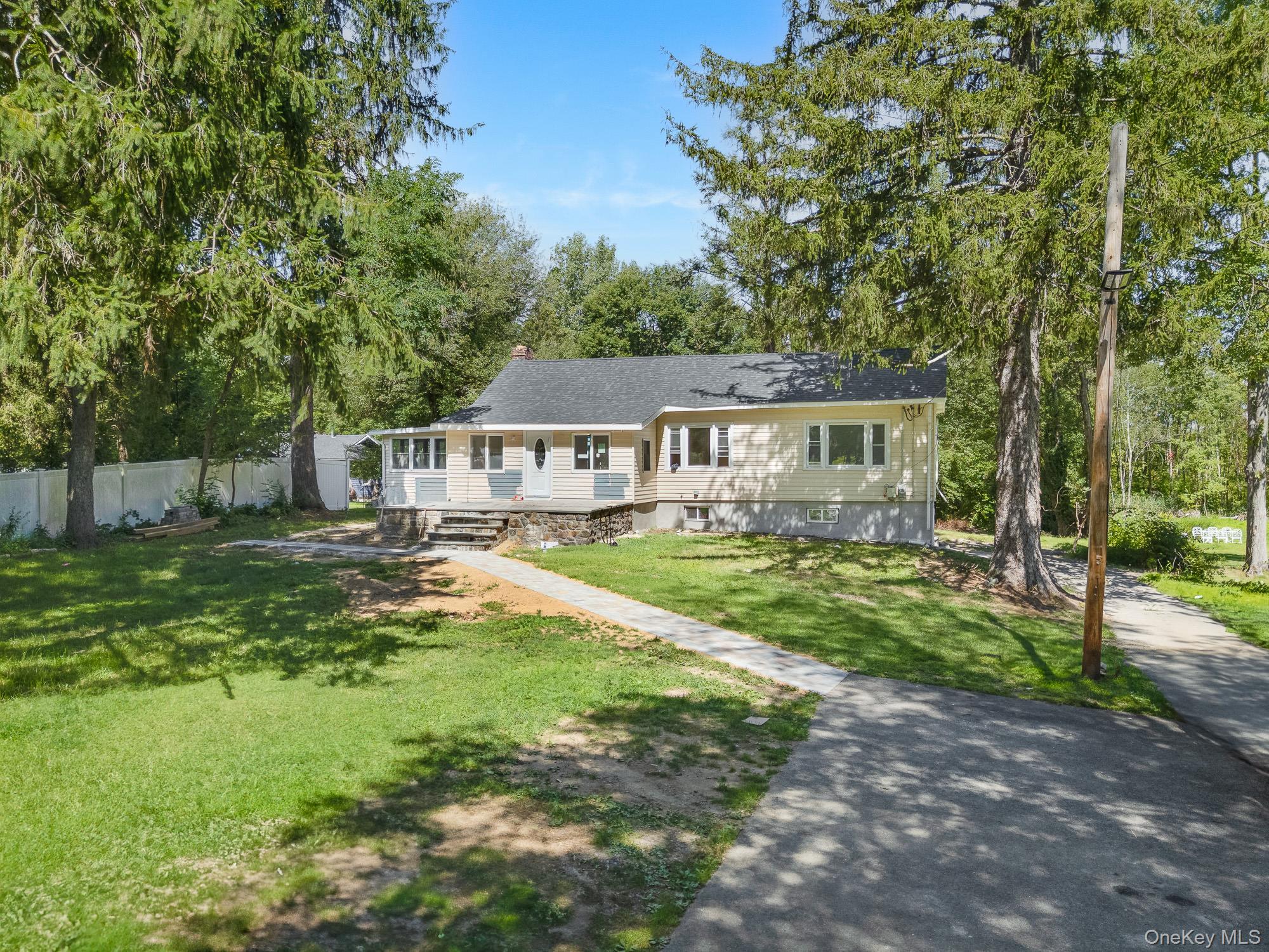 Nestled on nearly one acre of lush, private grounds in the desirable Y...