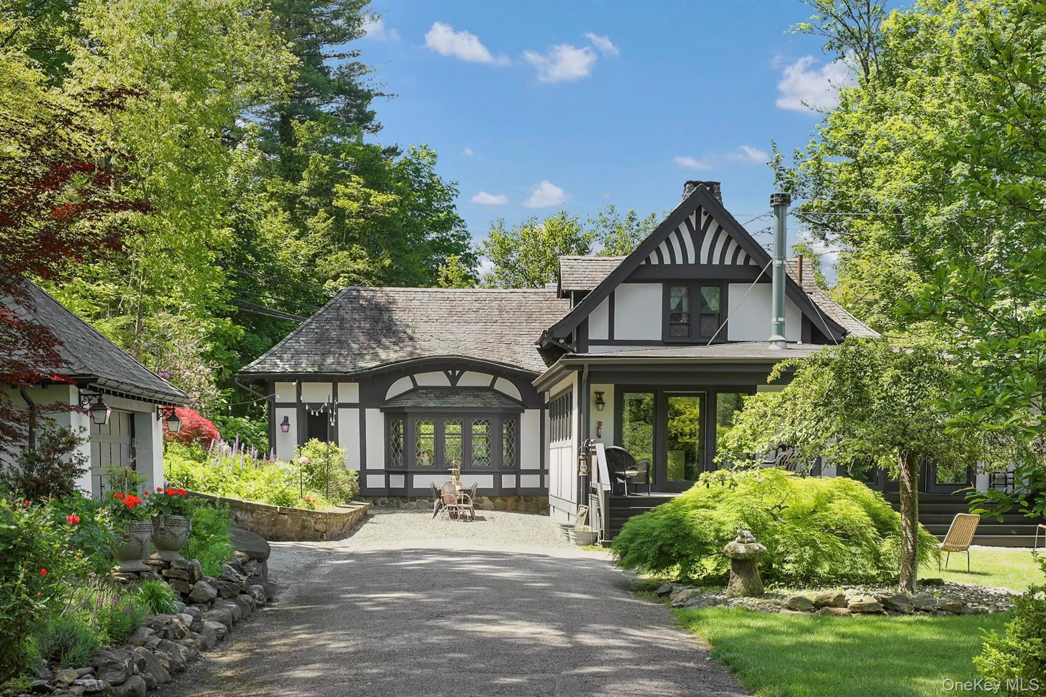 Behind stately iron gates on a quiet, tree-lined street in the heart o...
