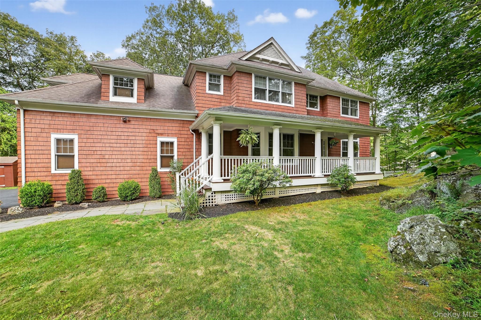 This Stunning Front Porch Center Hall Colonial sits majestically on be...