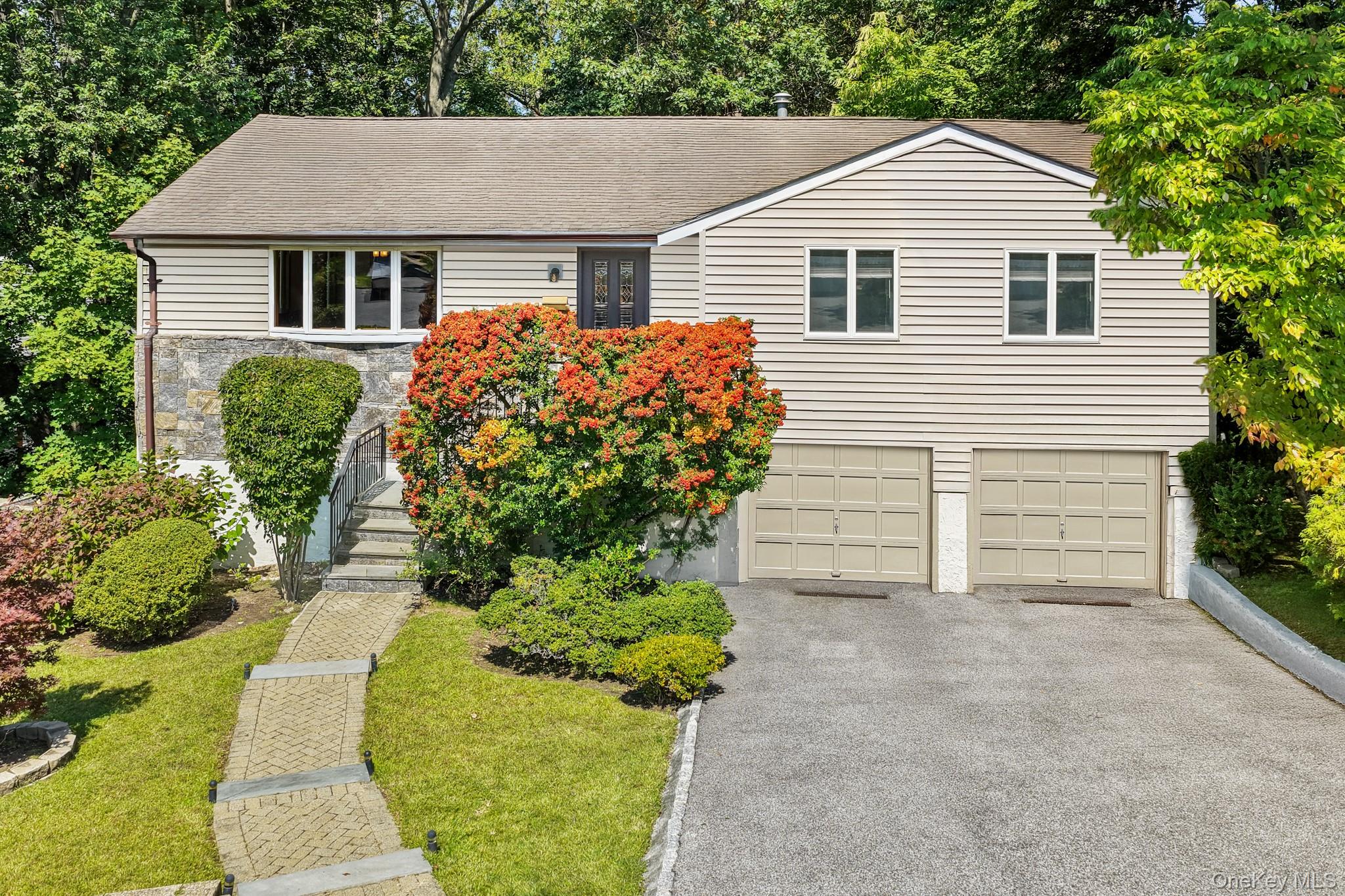 Tucked along a private, tree-lined street, this inviting four-bedroom,...