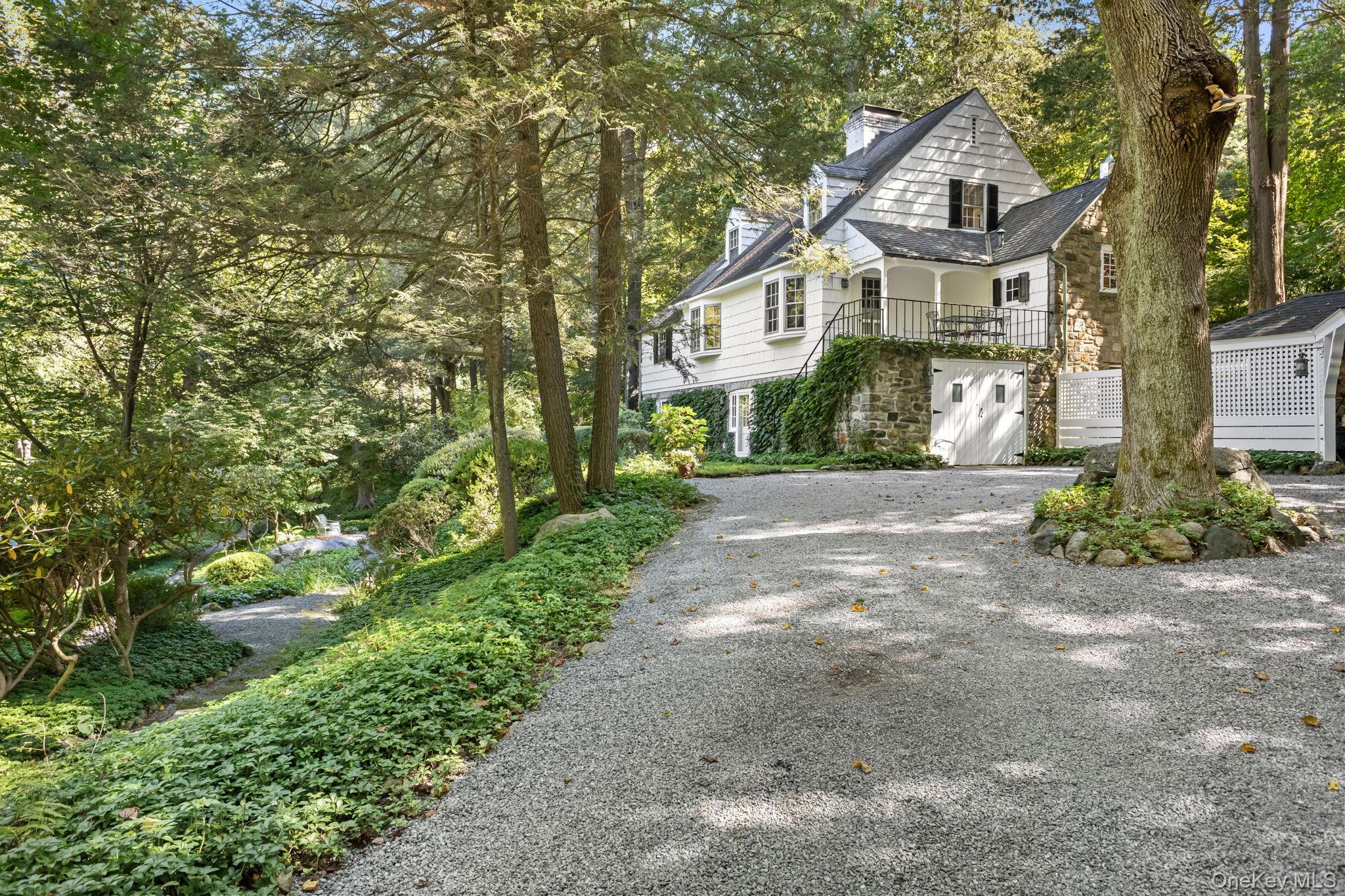 Set on 3.25 private acres of lush formal gardens and mature woodlands,...