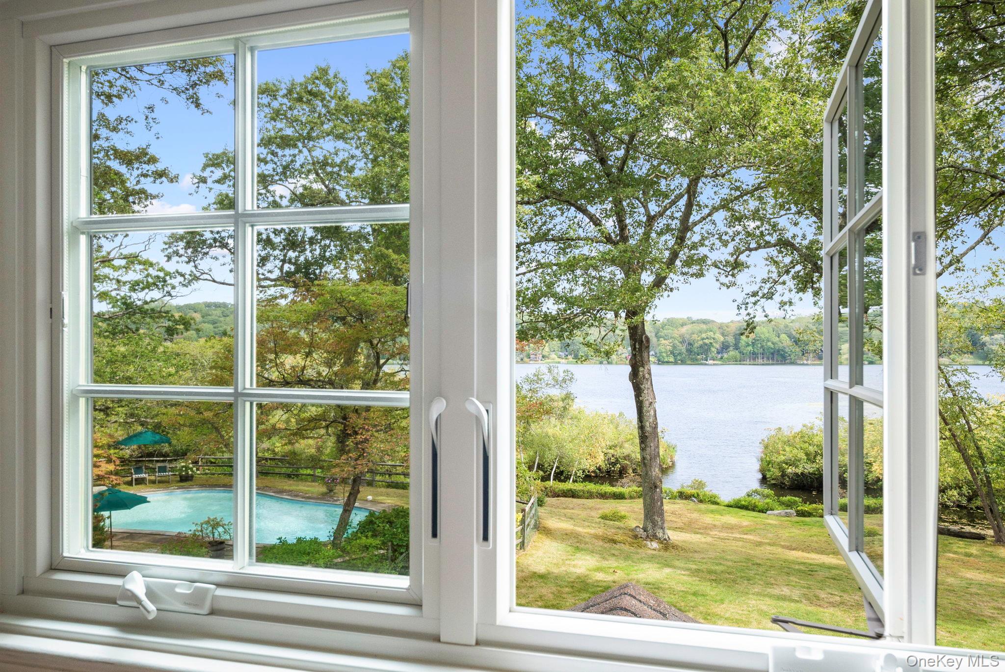 Rare lakefront privacy in this charming 1940's vintage home with lakes...
