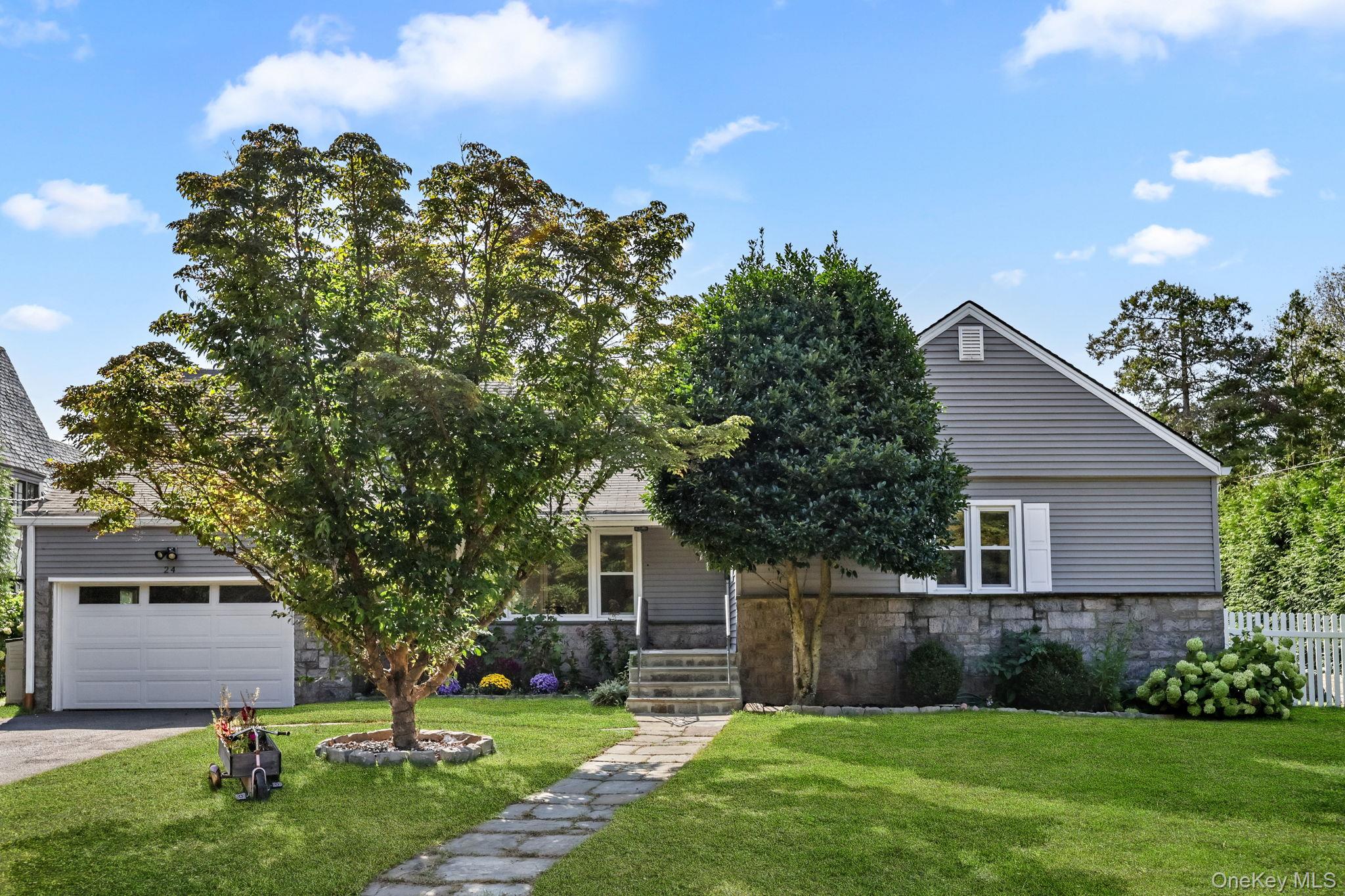 Sunny and spacious Cape style home set on a tranquil street with a won...