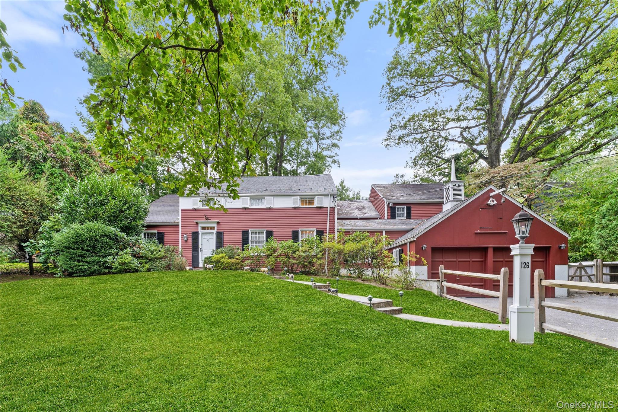 Set on pristine, park-like grounds, this timeless farmhouse Colonial b...