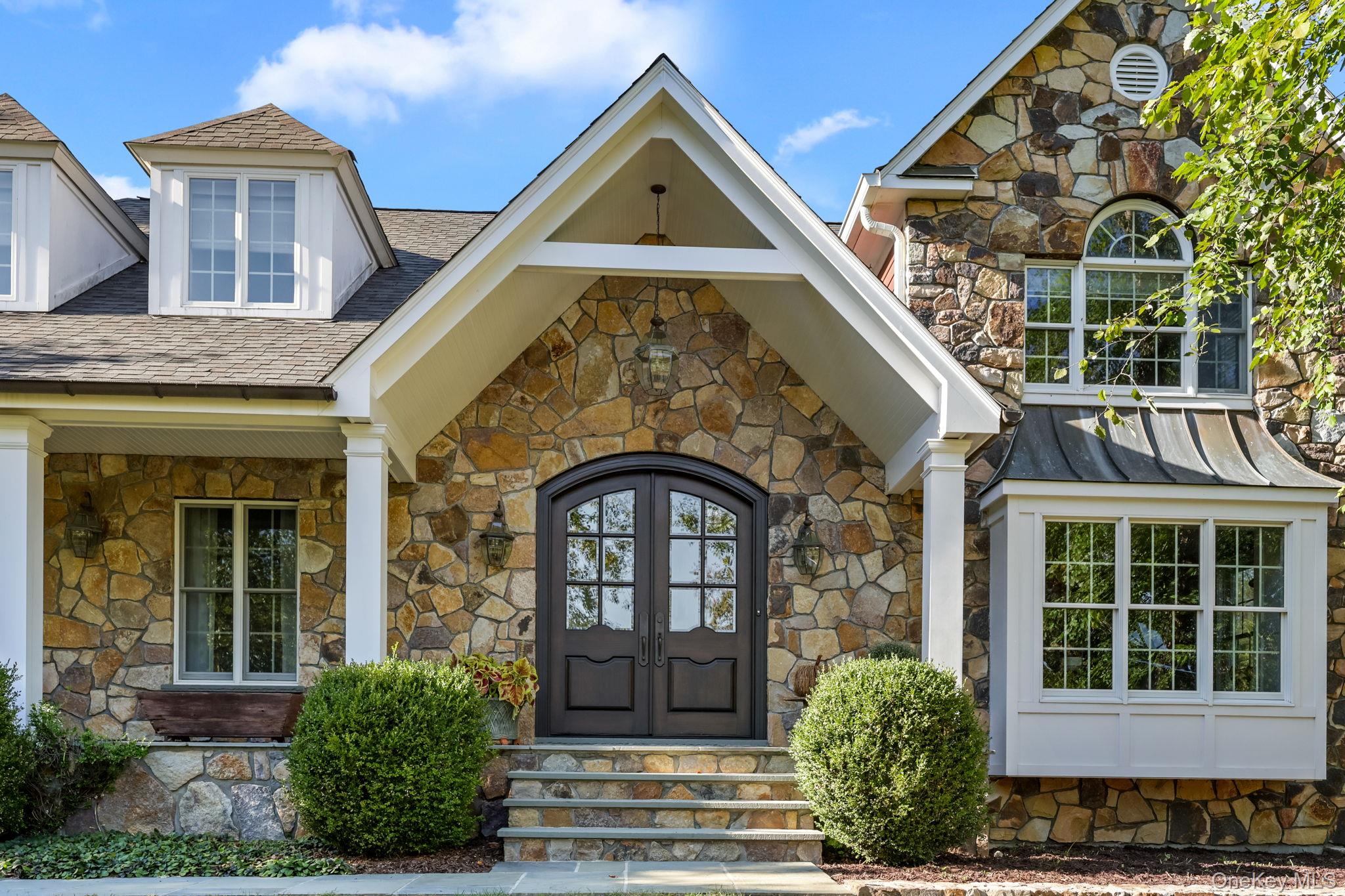 Beautifully sited on a hill in the desirable Primrose Farms community...