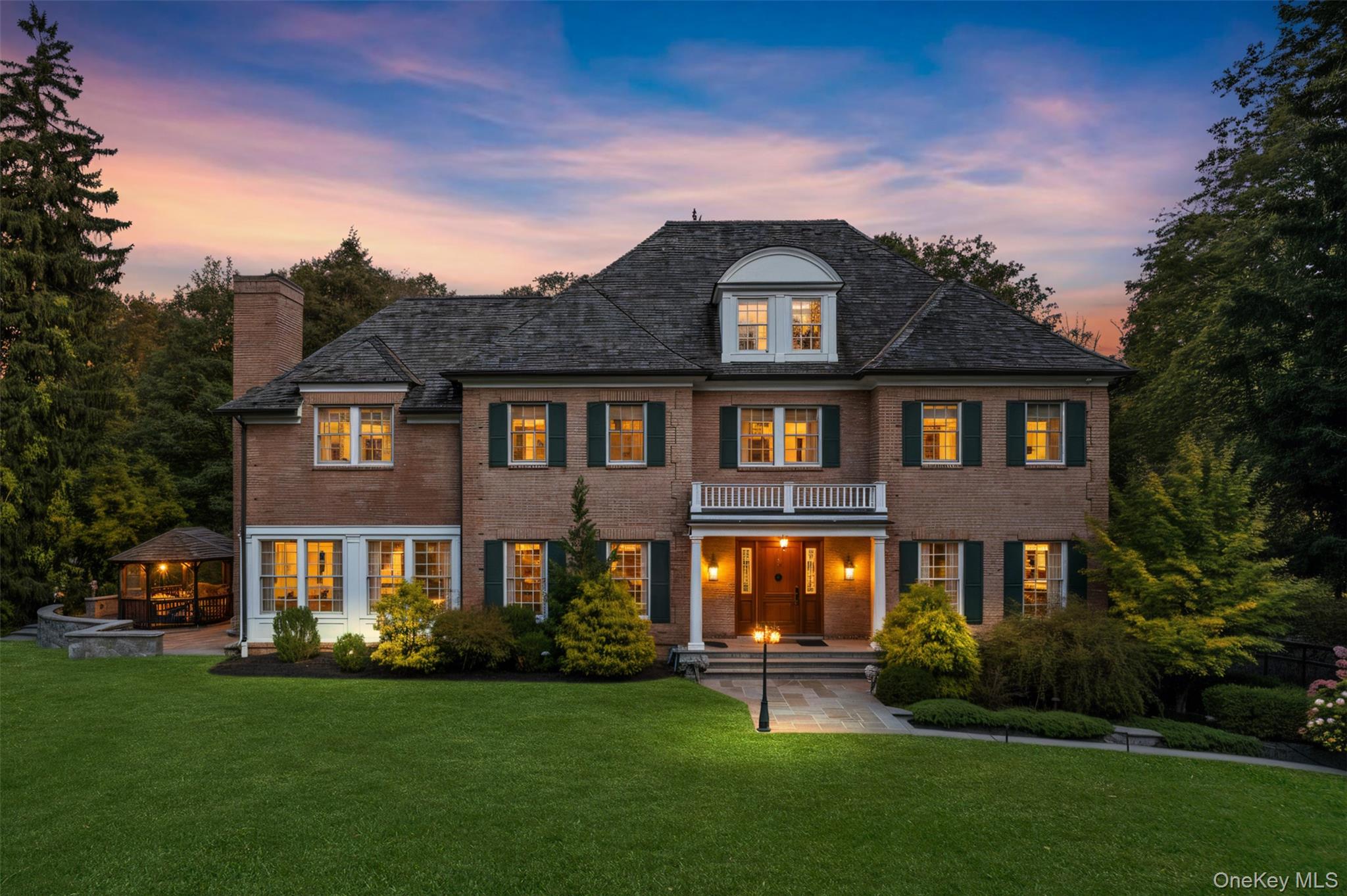 Privately gated and masterfully crafted, this exceptional custom brick...