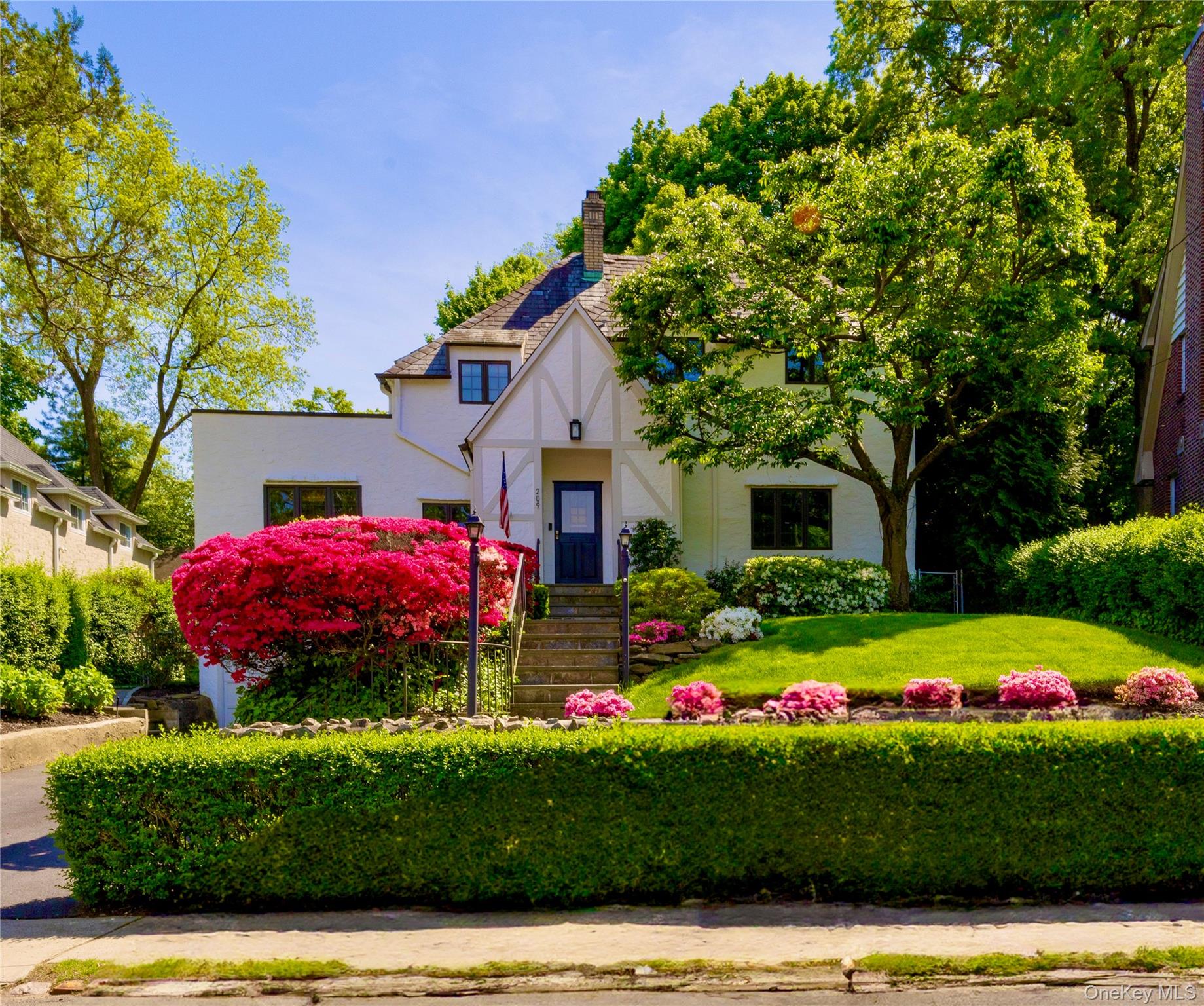 Classic stucco English Tudor nestled in the heart of iconic Cedar Knol...