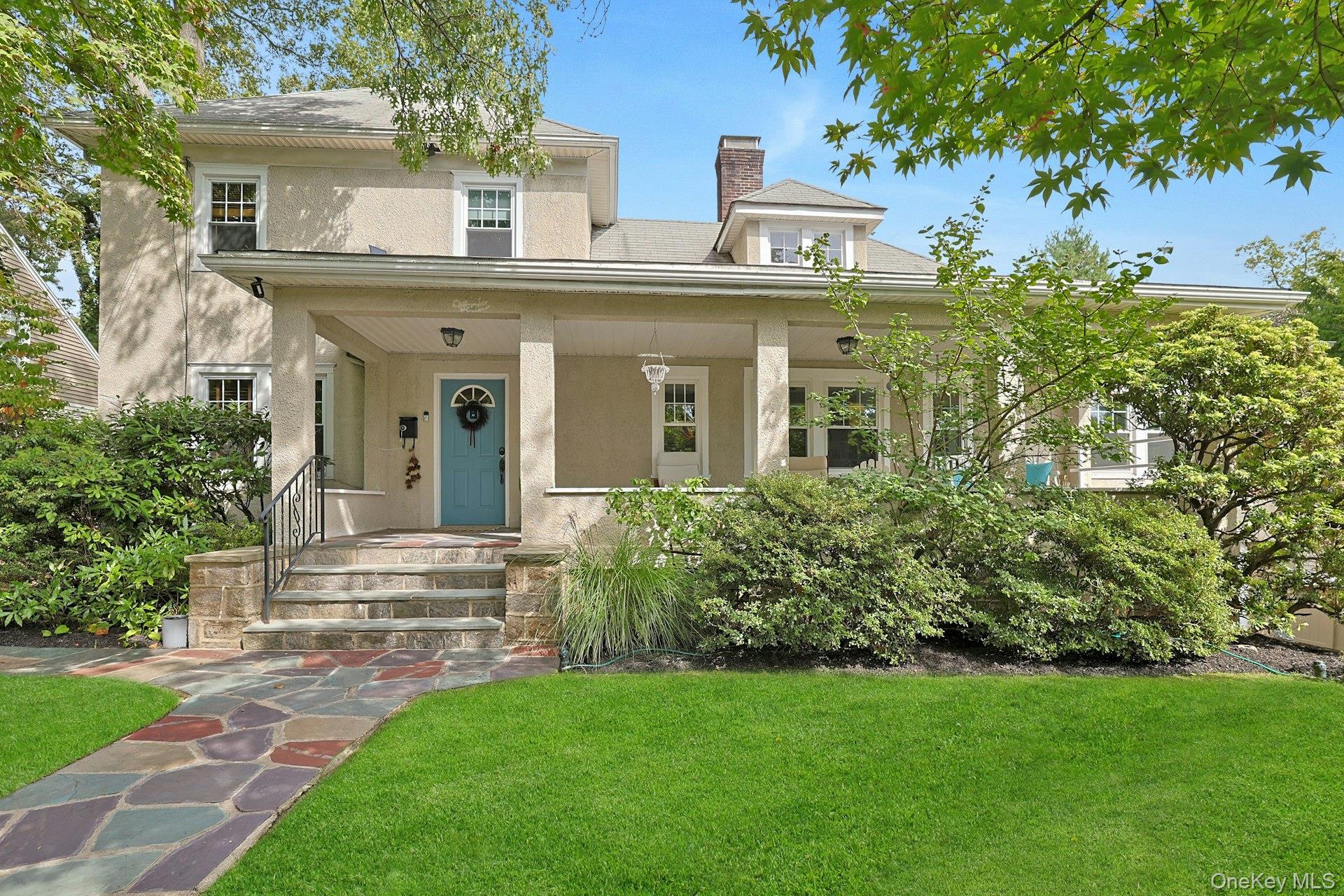 This Stucco Colonial with delightful front porch exudes warmth and cha...