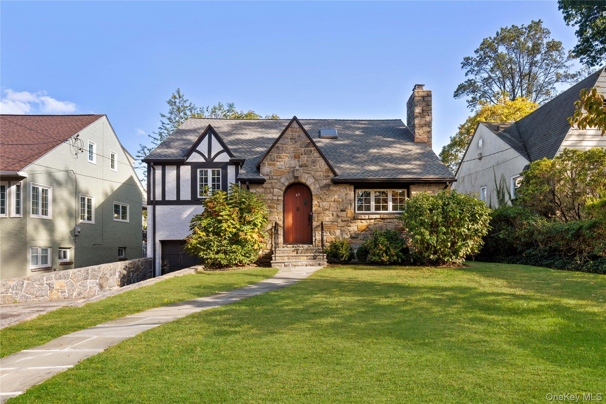 This stunning split-level Tudor in Hunt’s Wood, just steps from the Br...