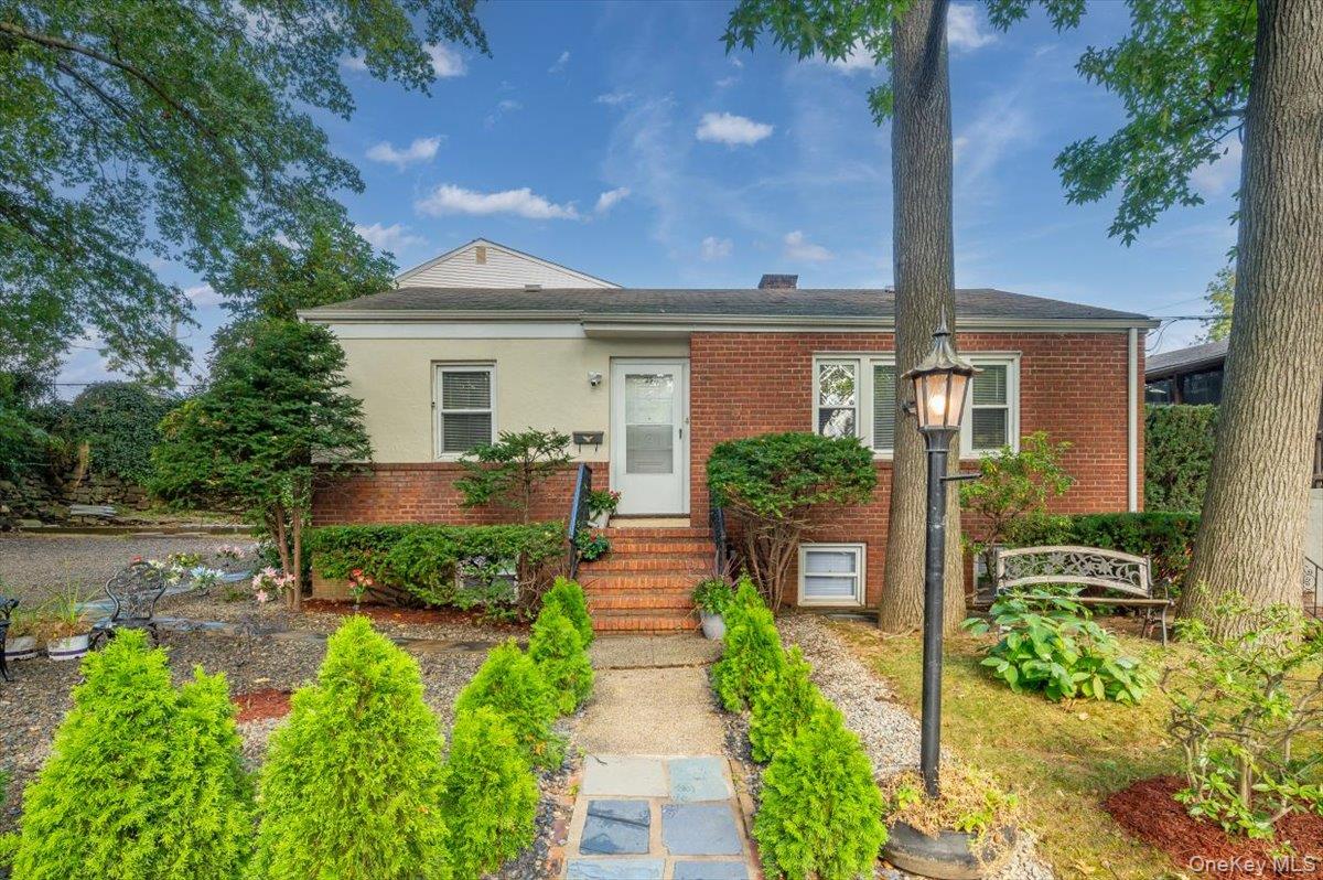 Nestled on a beautifully landscaped corner property in a quiet, tree-l...