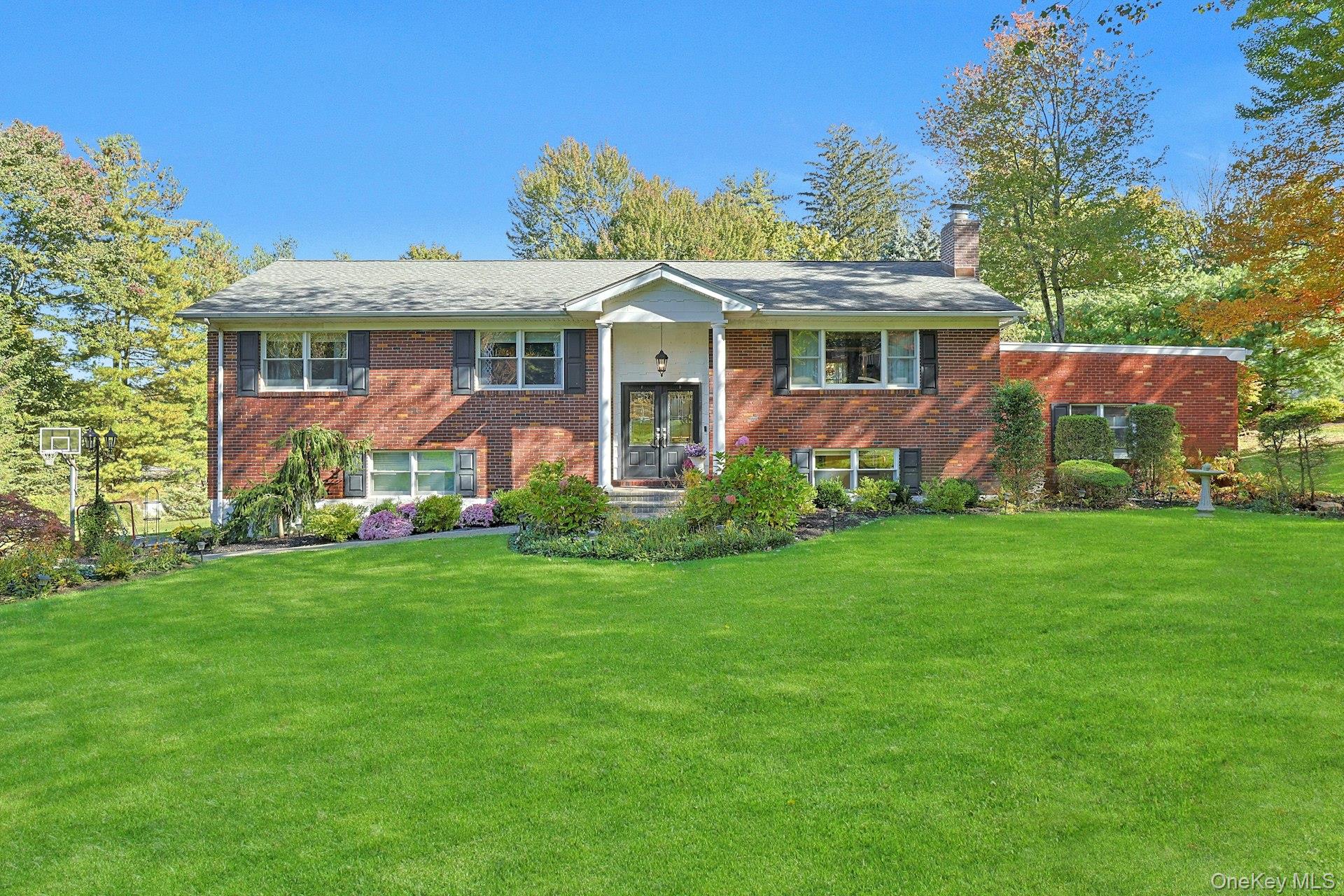 Welcome to this stunning brick Raised Ranch, privately nestled on a se...