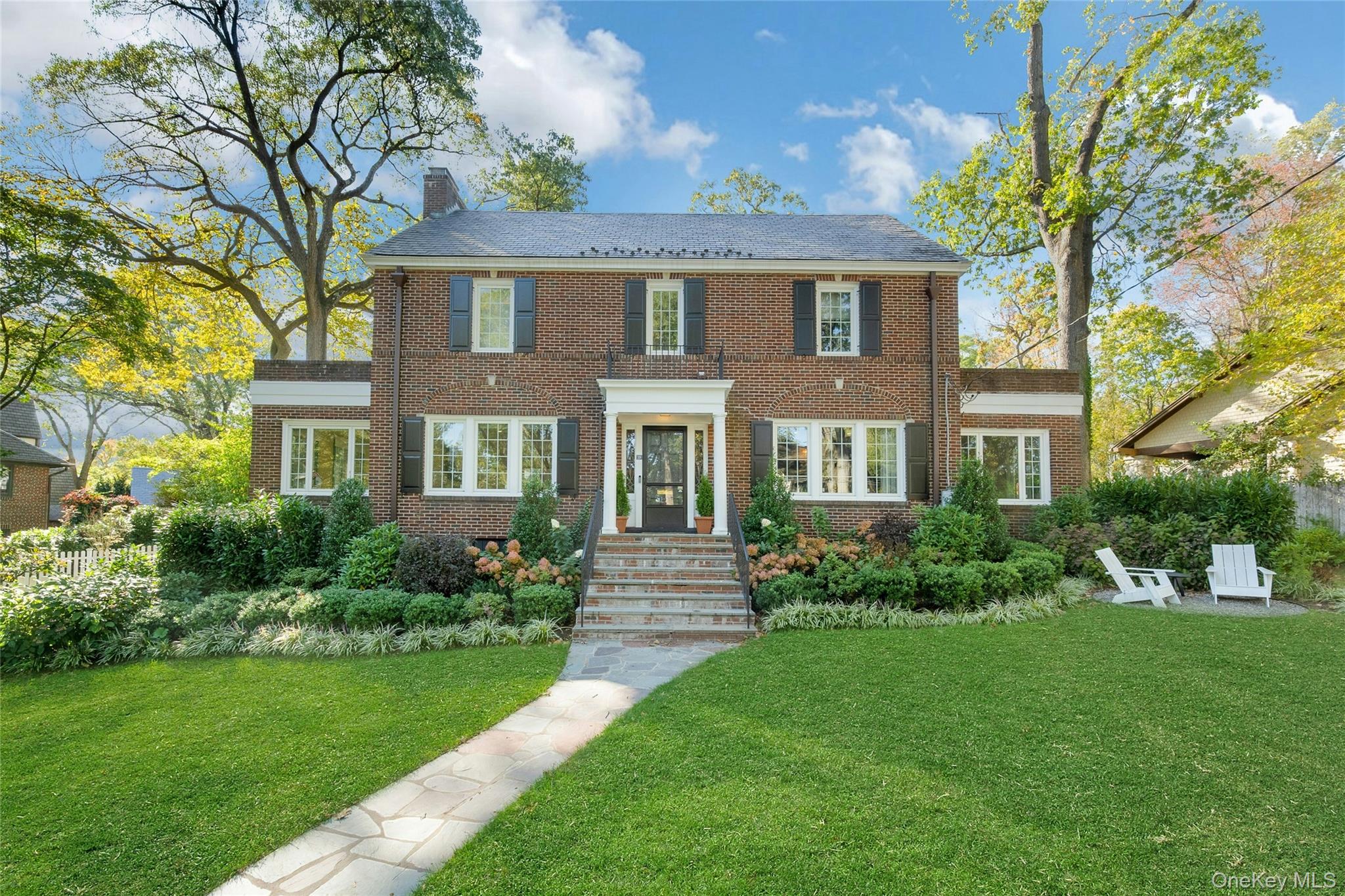 This classic brick center-hall Colonial seamlessly blends timeless arc...