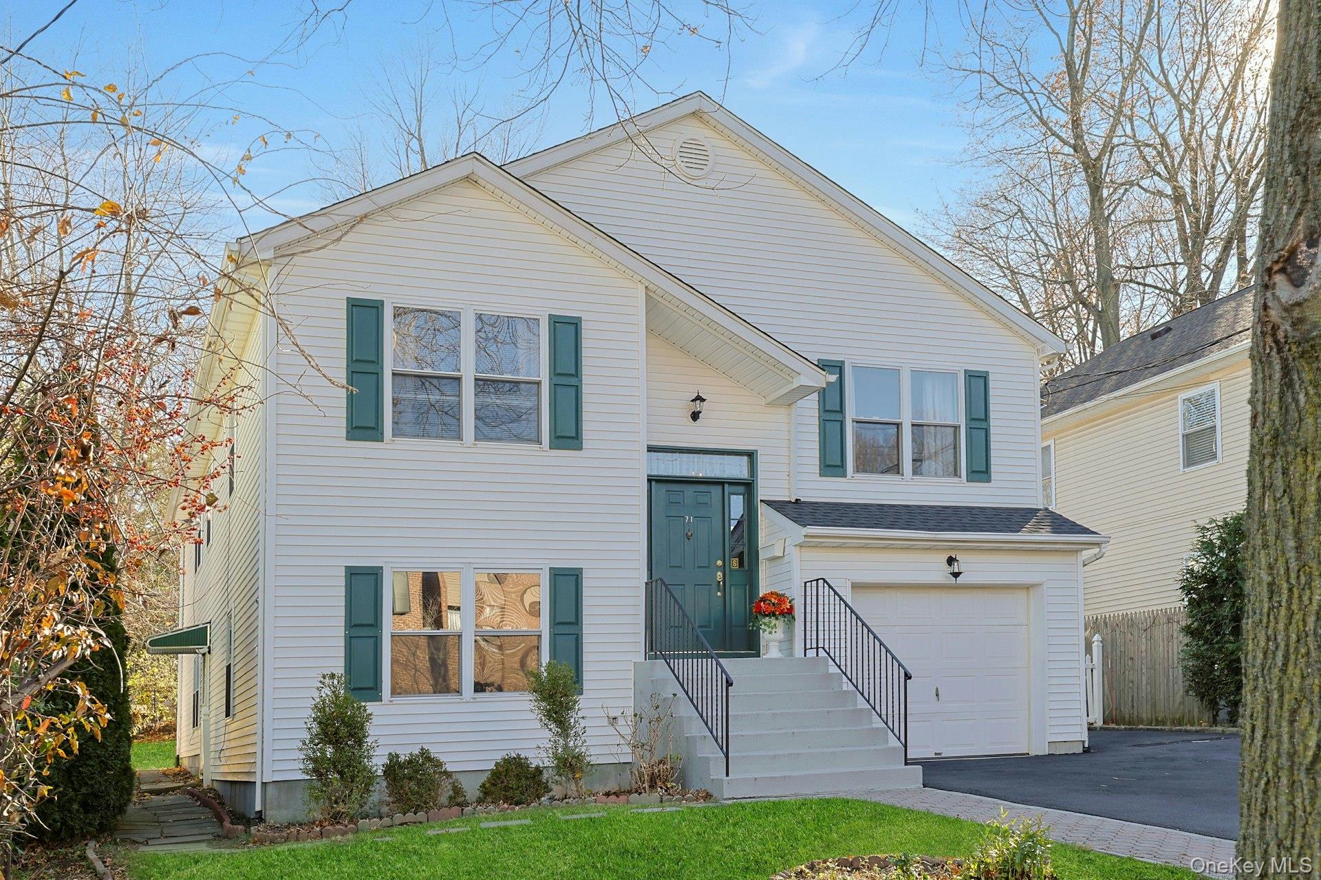 Welcome to 71 Holland Ave a beautiful split level ranch. Grand vaulted...