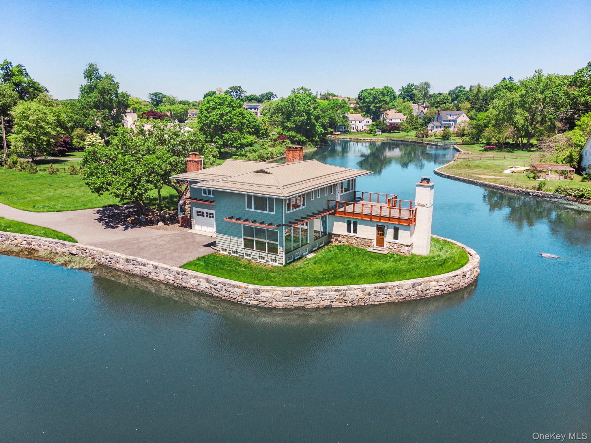Nestled in a serene waterfront enclave in Larchmont, where wildlife ab...