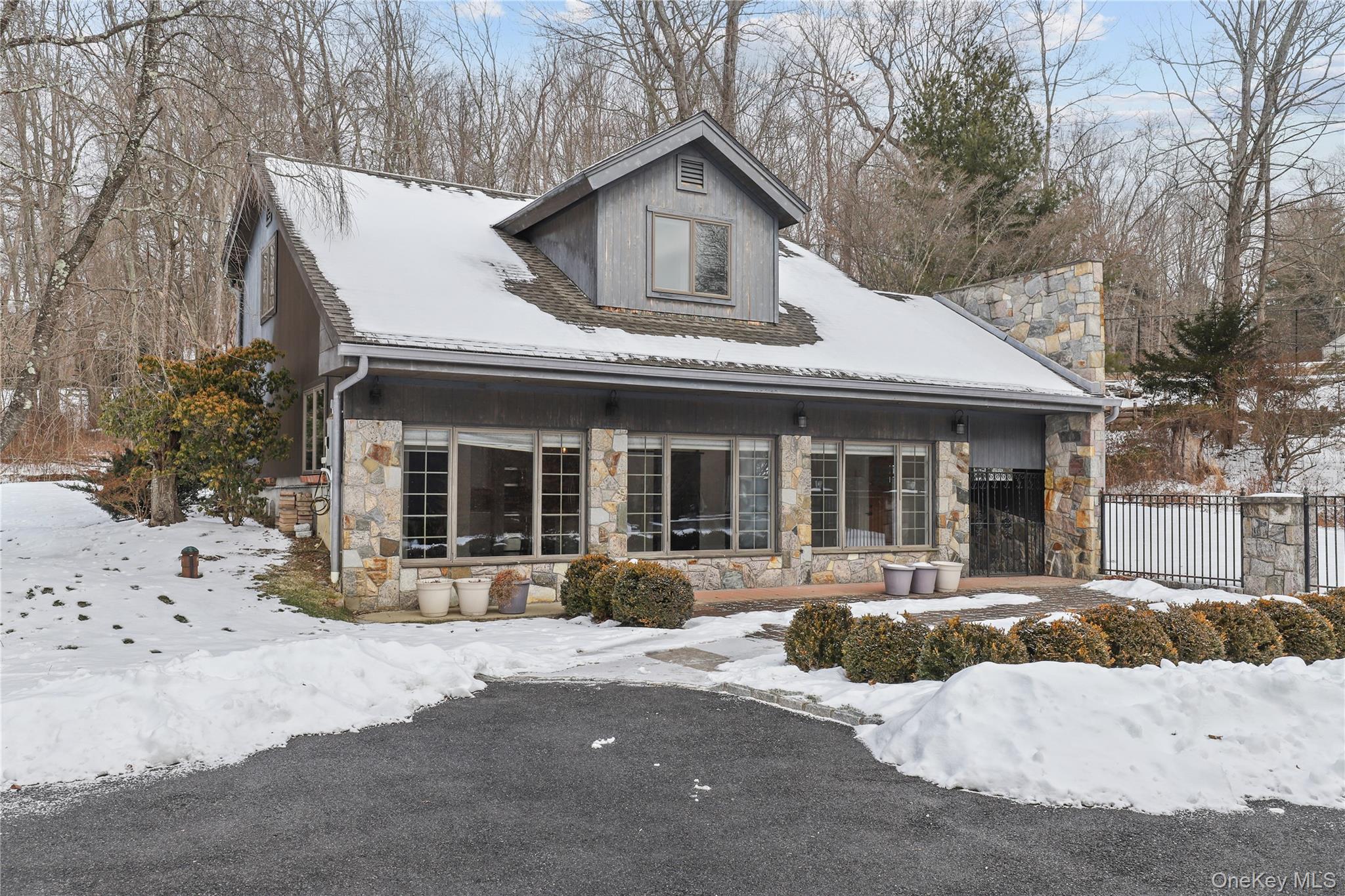 This light-filled stone carriage house set on 5.7 private acres(which...
