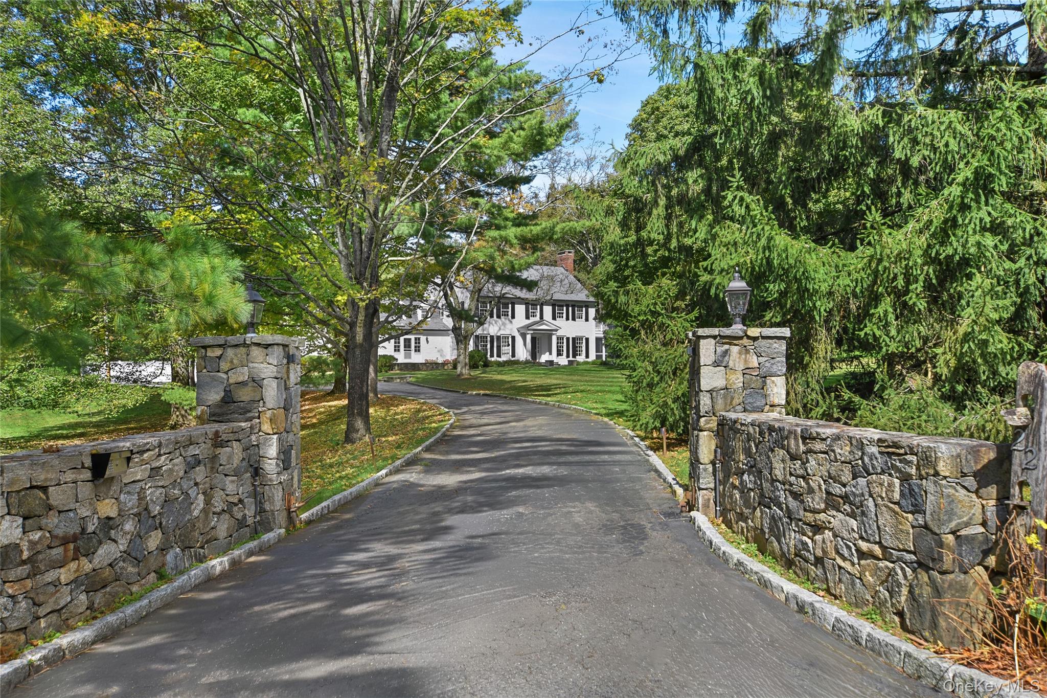 So classically Bedford. White clapboard colonial on nearly five gated...
