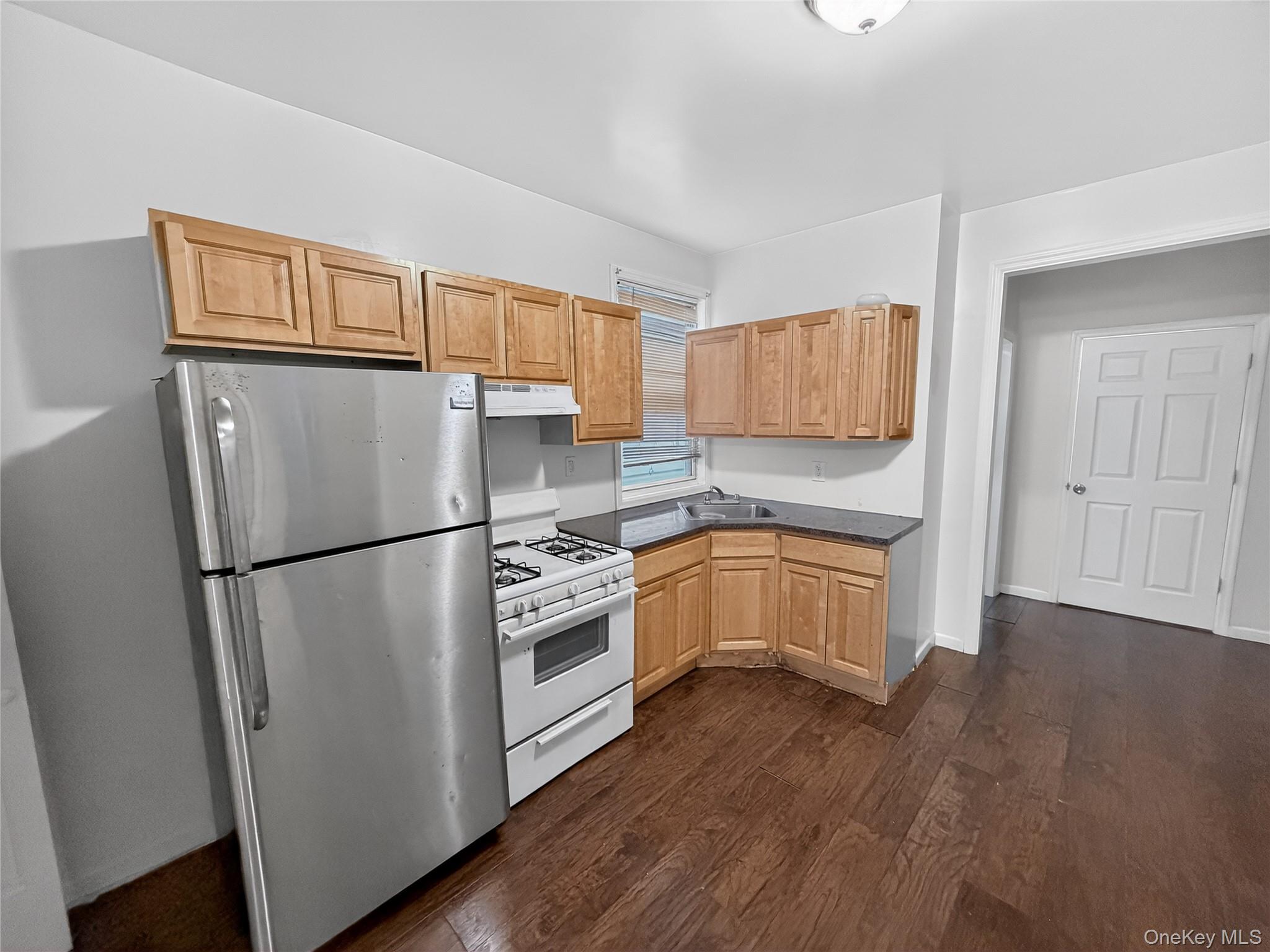 Bright two bedroom apartment featuring dark wood style flooring and fr...