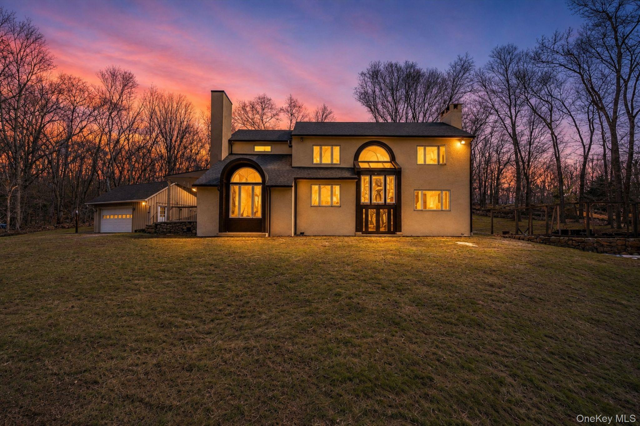 This private, Colonial-style residence sits on 2.5 partially wooded ac...