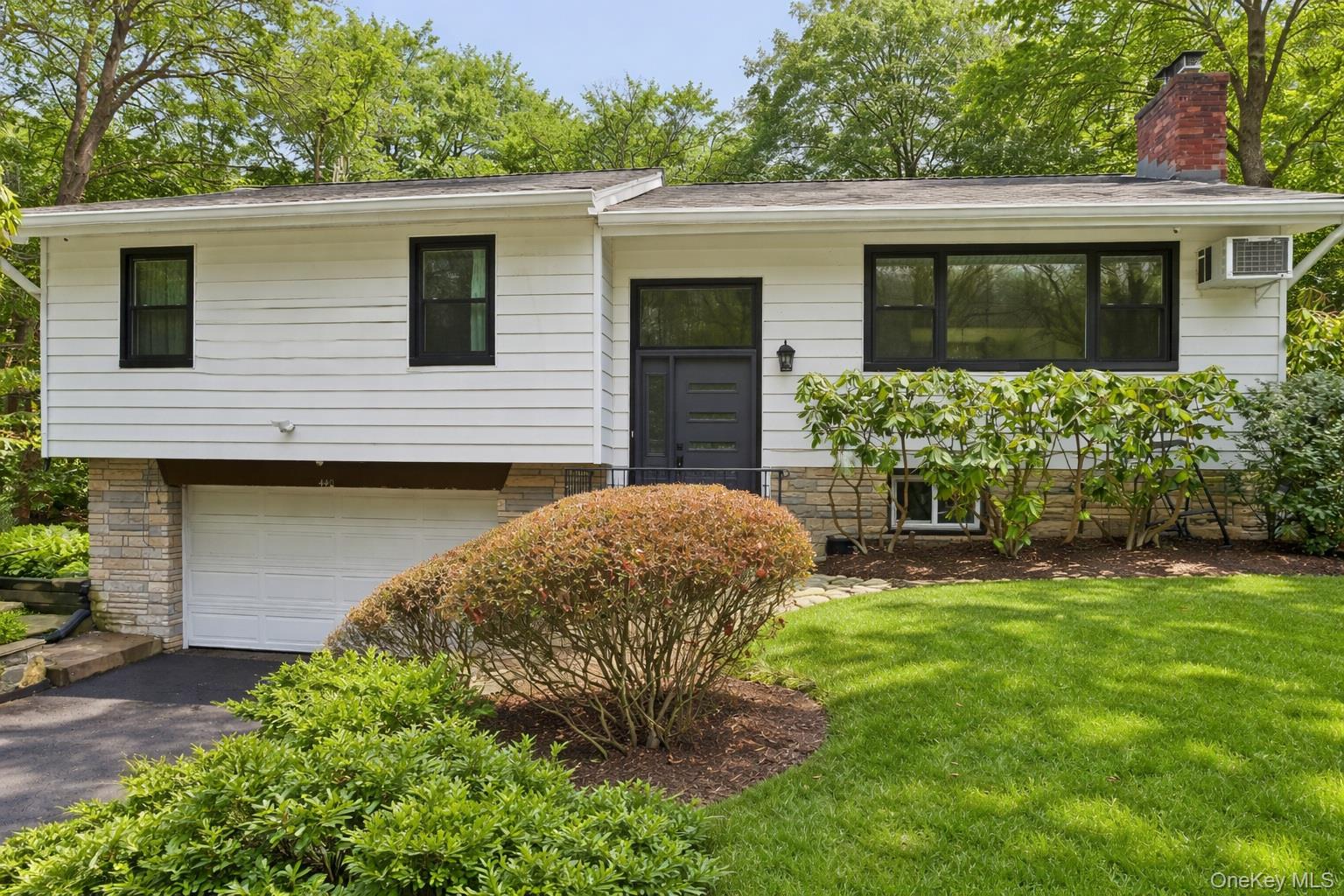 Nestled on a quiet residential street, this well-maintained raised ran...