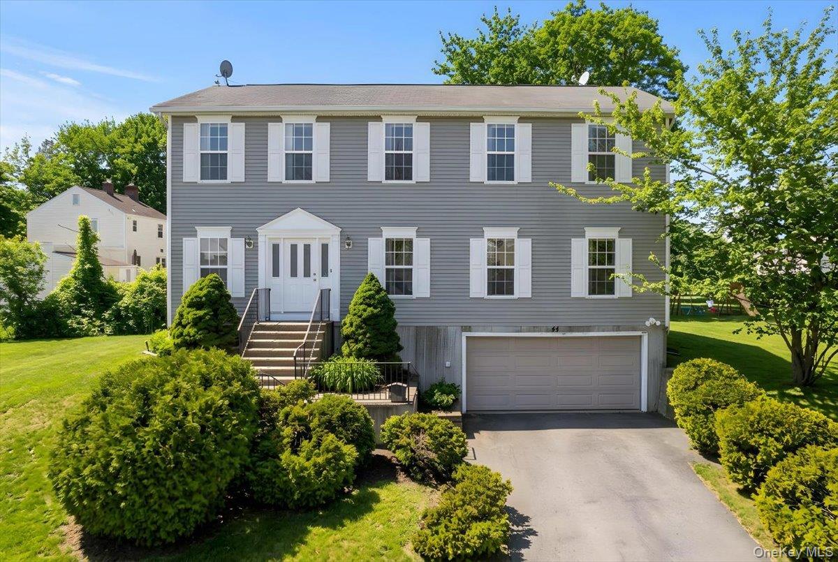 Beautifully updated and move-in ready, this sun-filled Colonial sits o...