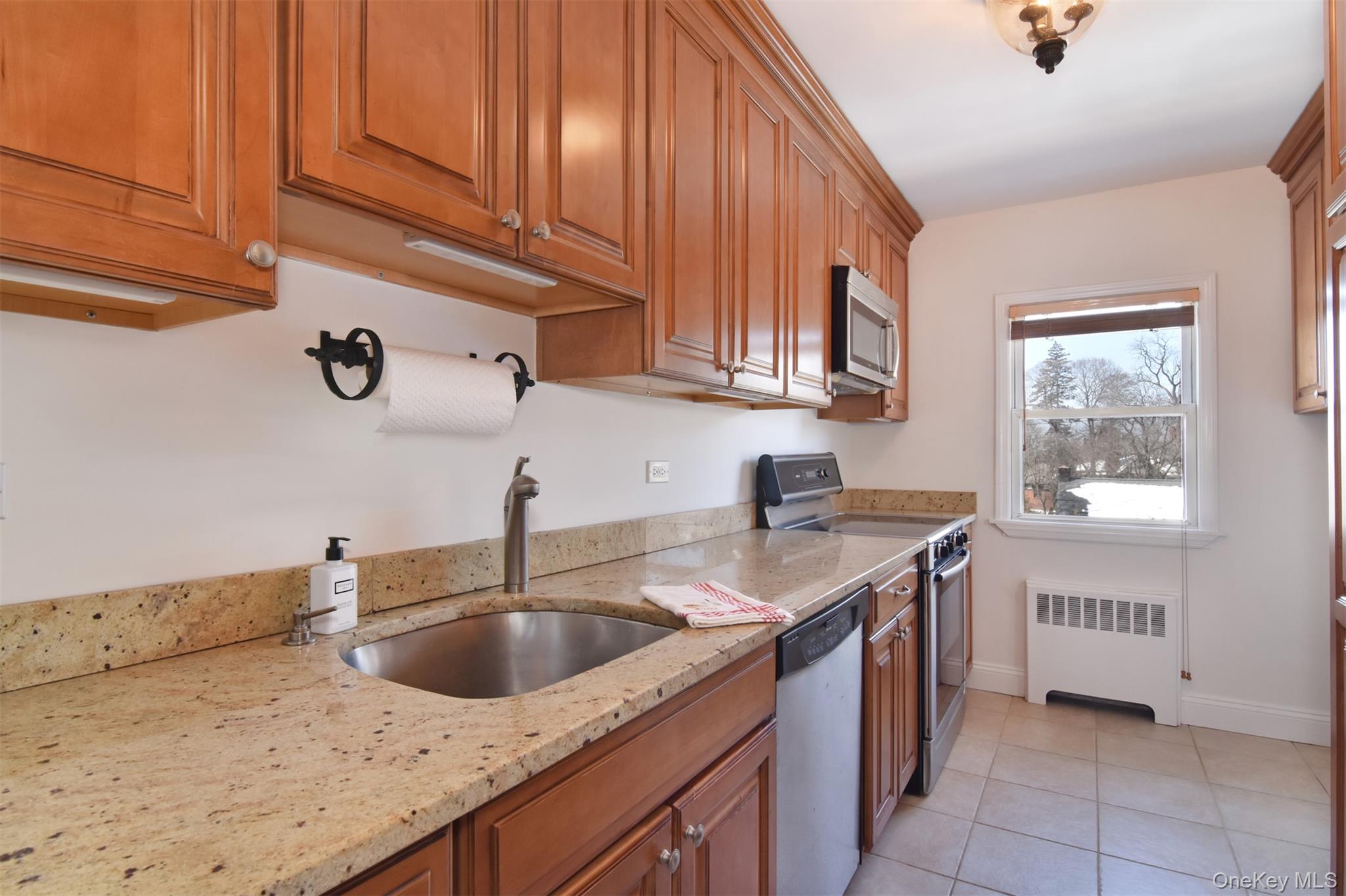 Sunny, nicely updated unit with eat-in kitchen w/granite tops, backspl...