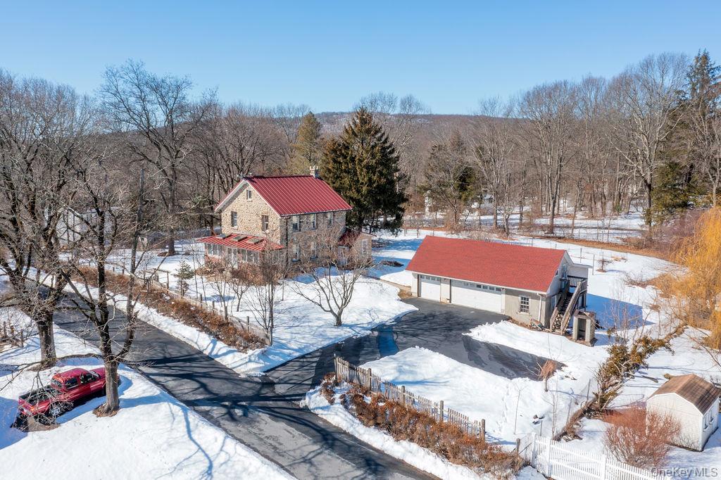 Set on a beautiful, one-acre flat lot, this distinctive stone home off...