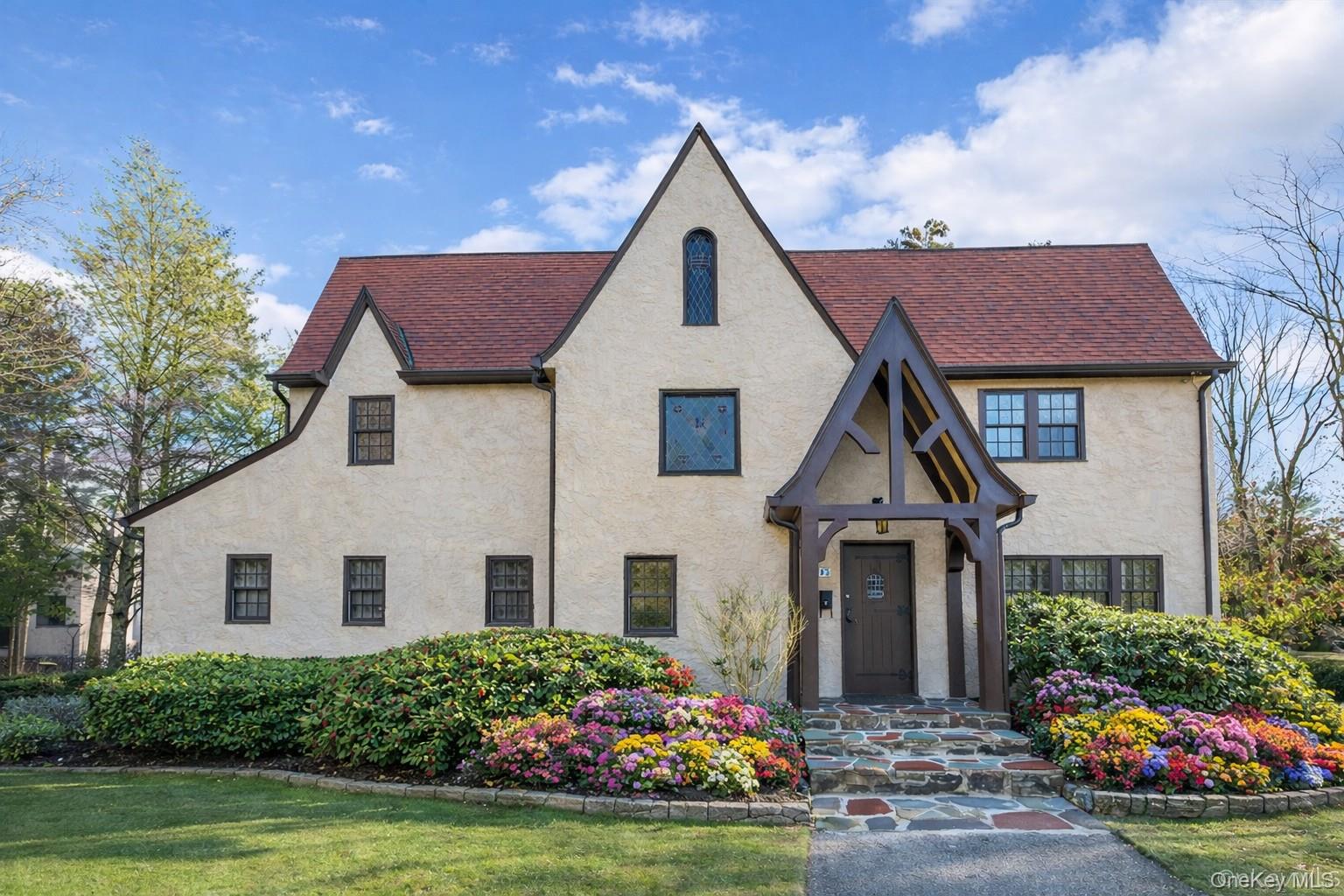 Perched behind a stately stone wall on one-third acre in New Rochelle'...