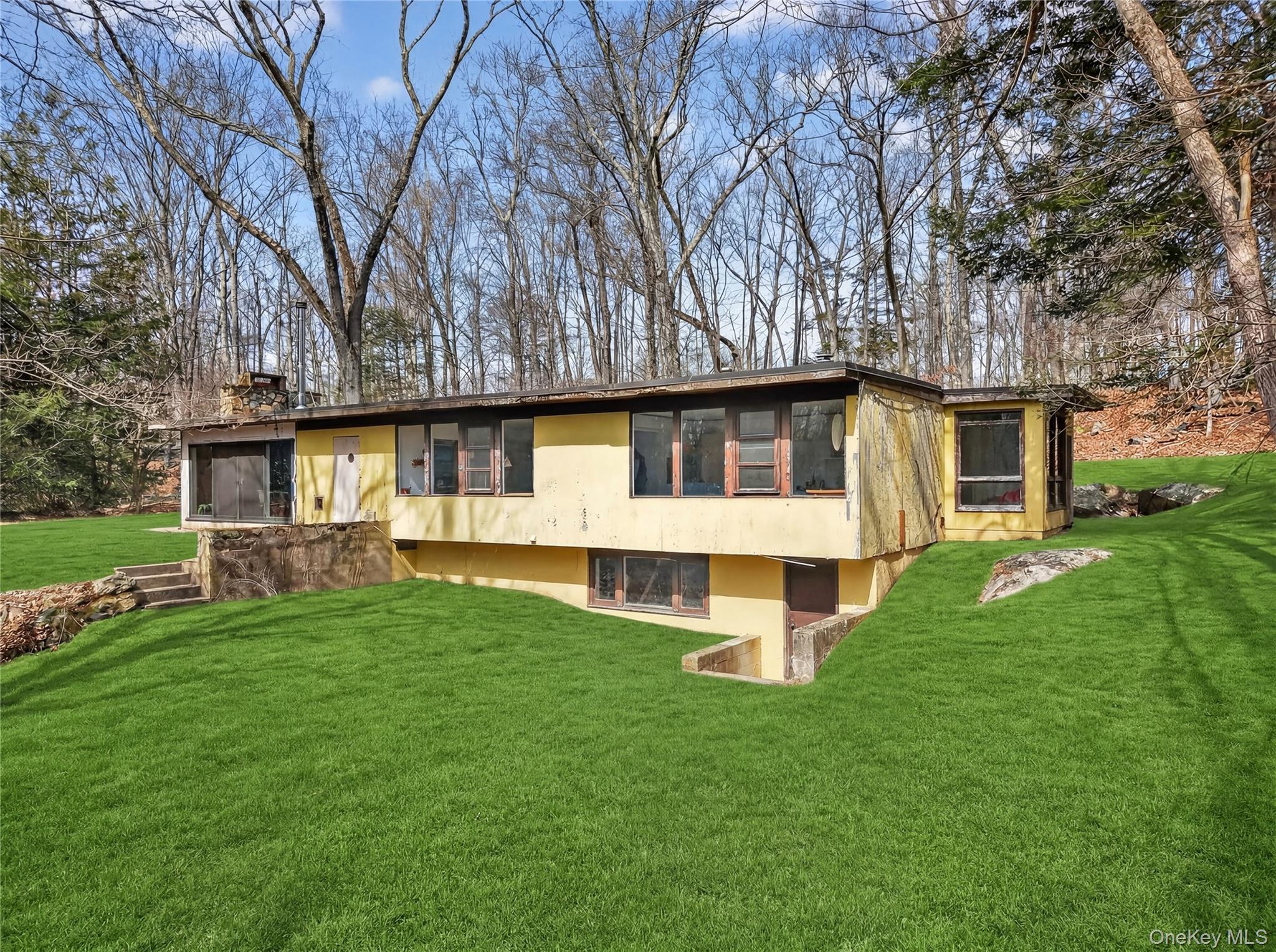 Dramatic mid century modern home placed in an incredible setting. Wall...
