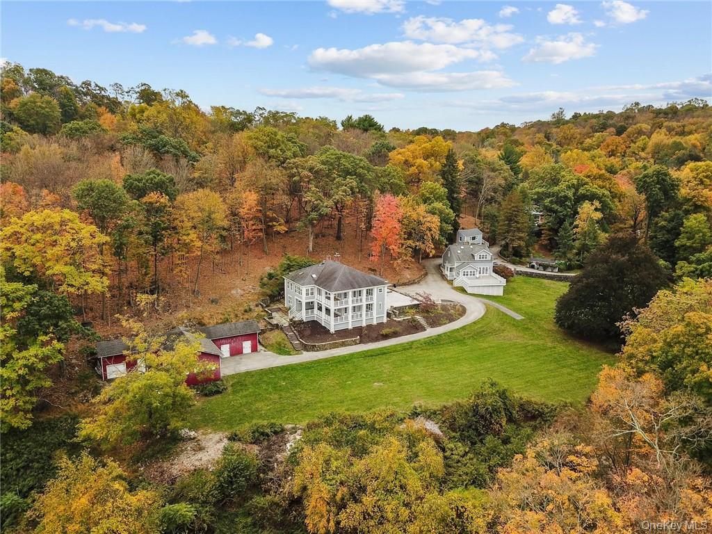 Welcome home, where a charming stone wall entry leads to an expansive...