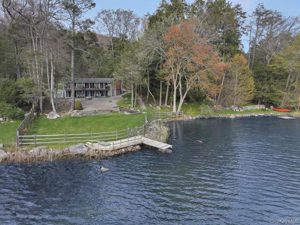 Set along the shoreline of Lake Oscaleta, this direct waterfront home...