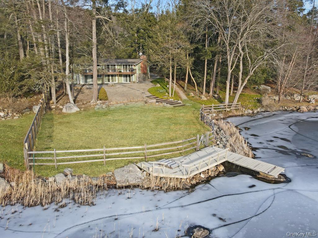 Set along the shoreline of Lake Oscaleta, this direct waterfront home...