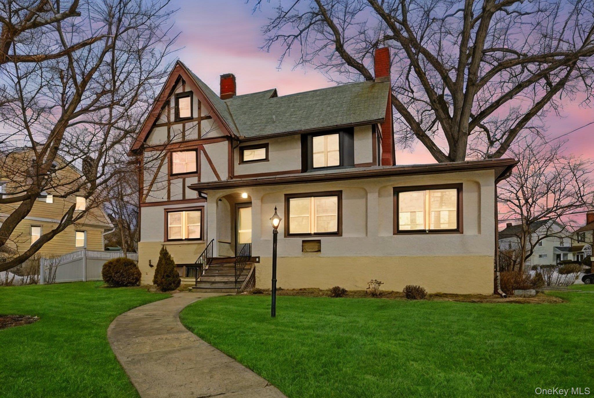 Stately Tudor home set on a prominent corner lot in the quiet Fisher H...