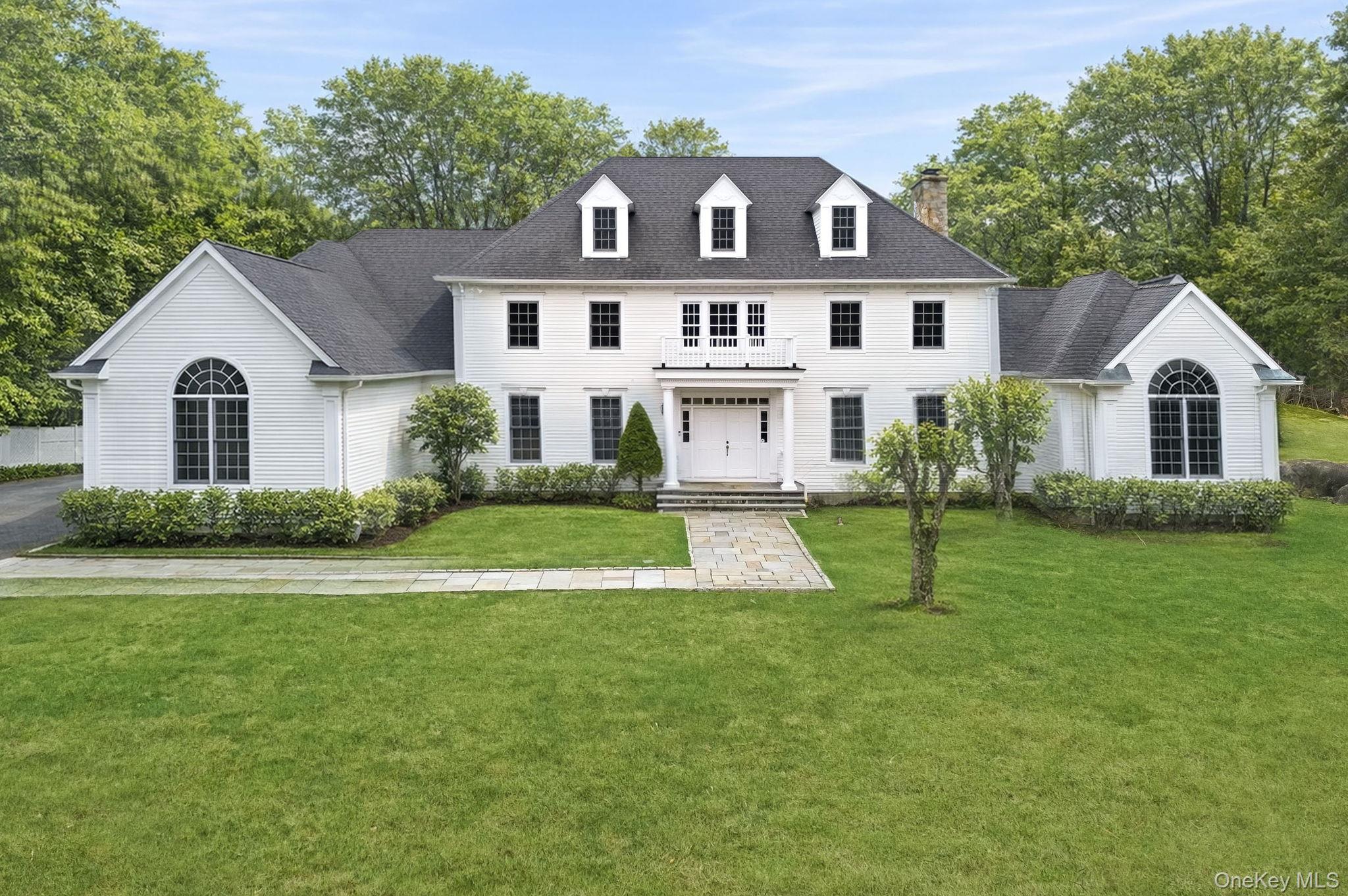 Elegant and timeless, this five-bedroom Georgian Colonial is set on a...