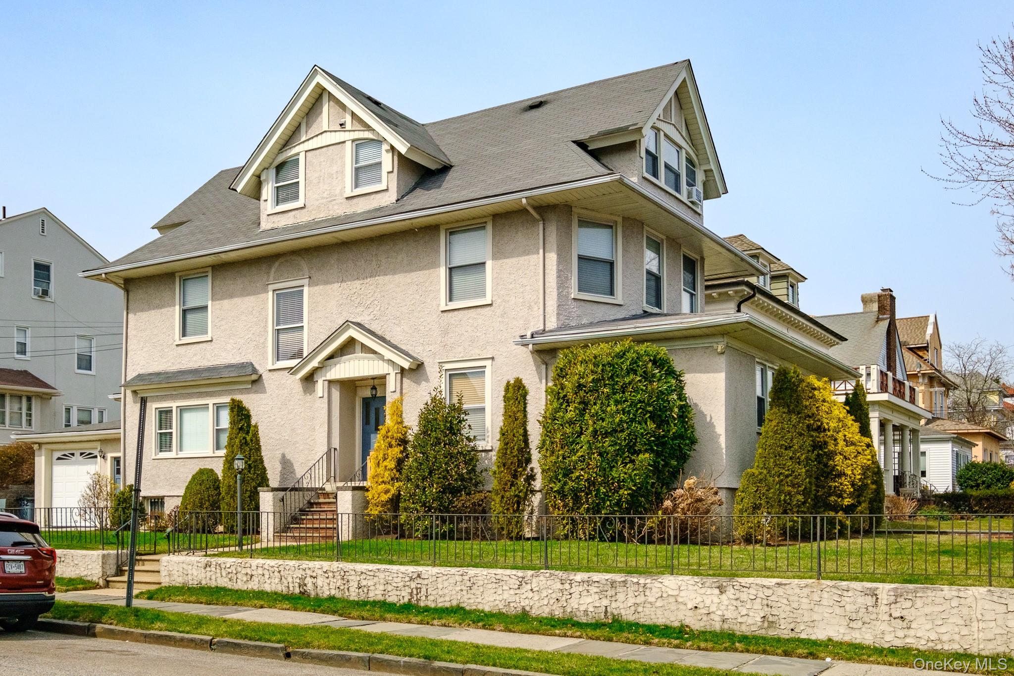 Stucco three-family with charm, character, and excellent curb appeal....