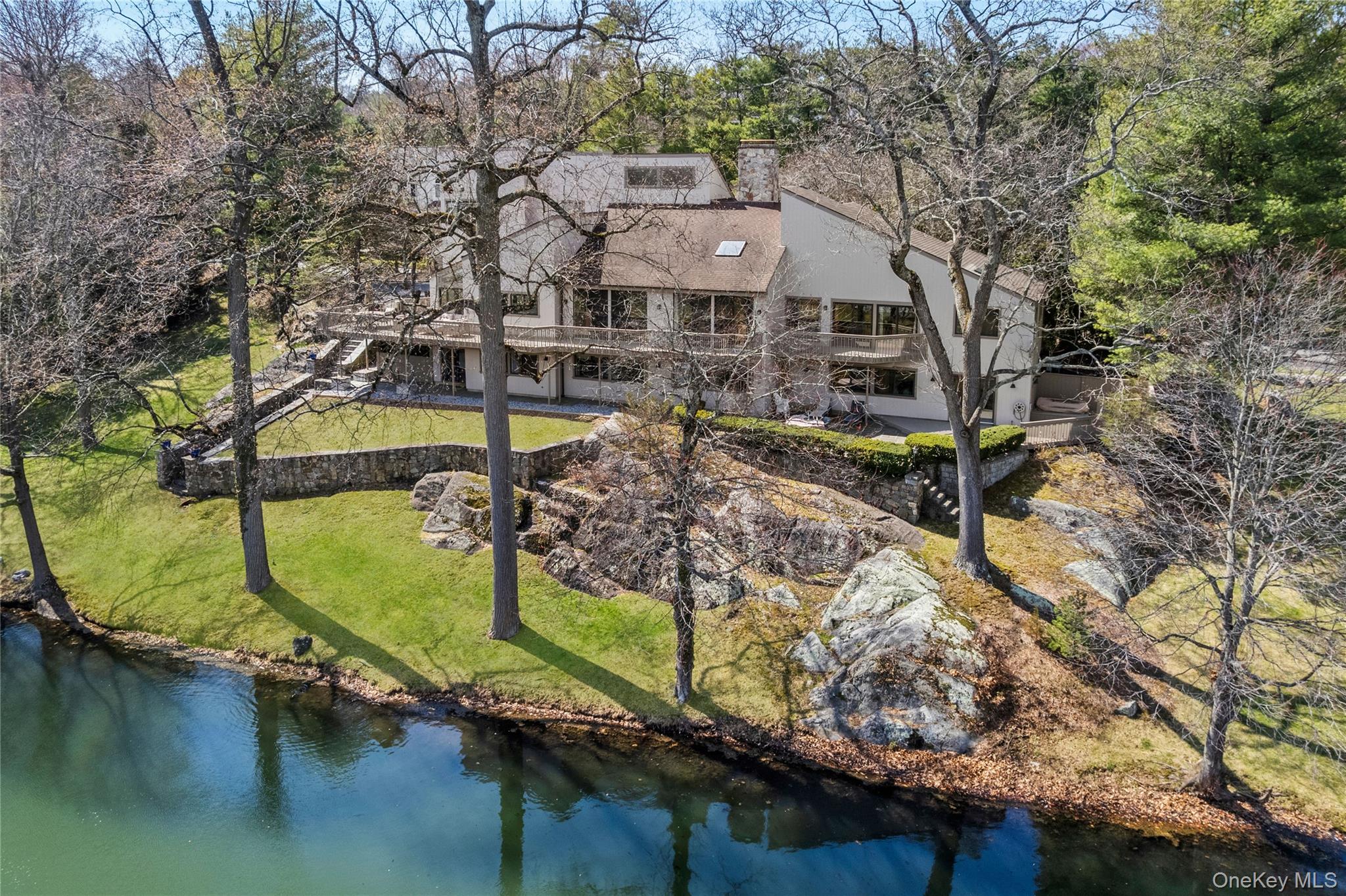 Discover true serenity at 3 Lakeside Drive, an exquisite 5,400 sq. ft....