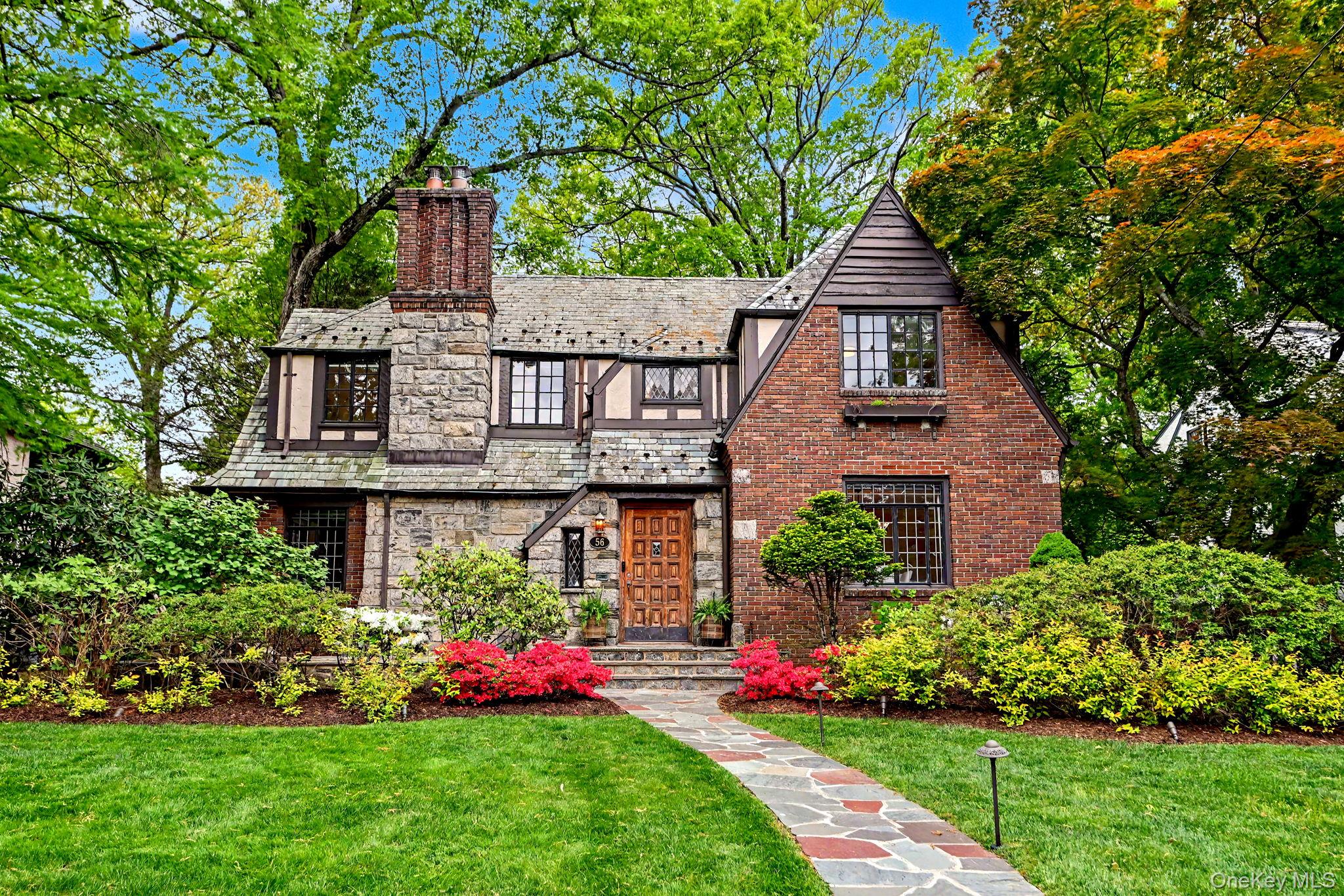 Classically elegant Tudor in coveted Larchmont Woods.
Perfectly sited...