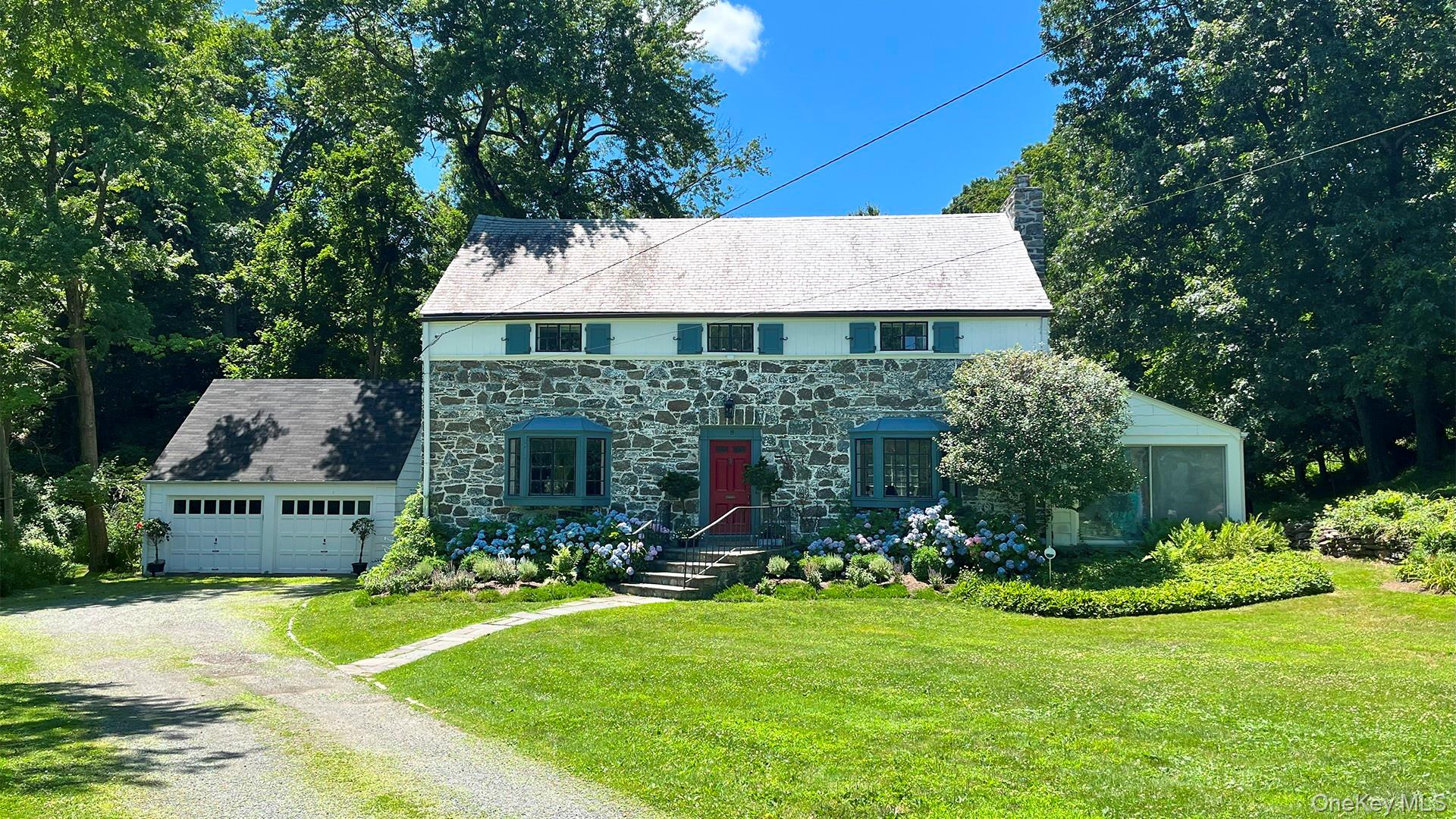 Nestled among blooming hydrangeas and old oak trees, this classic cent...