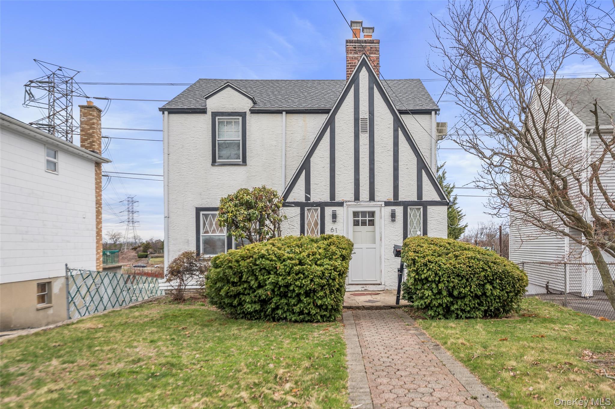 Welcome to 61 Round Hill Drive – a storybook Tudor that blends timeles...