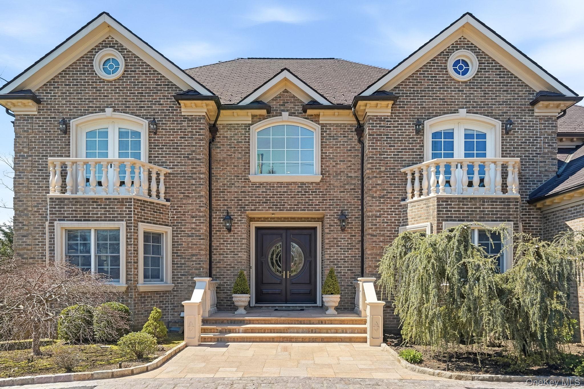 This stately center-hall brick and stucco Colonial, perfectly situated...