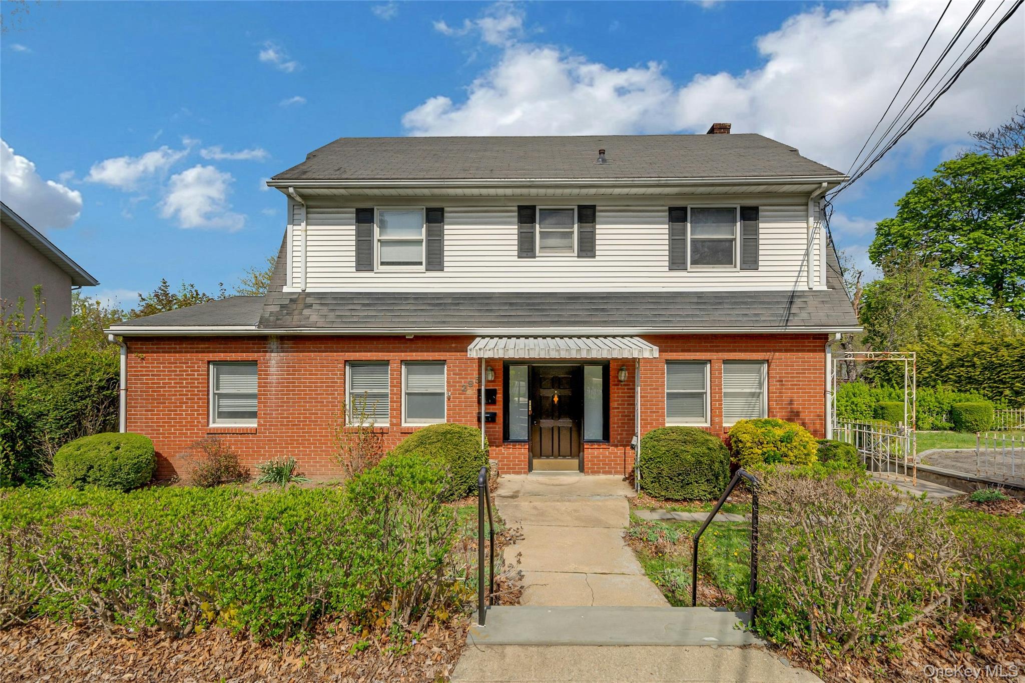 Legal two-family home set on an oversized lot in West Harrison. The ma...