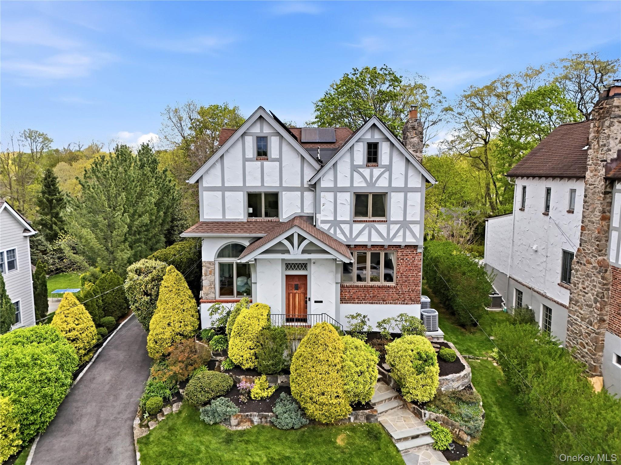 Beautifully renovated 4-bedroom, 4.1-bath modern Tudor blending timele...