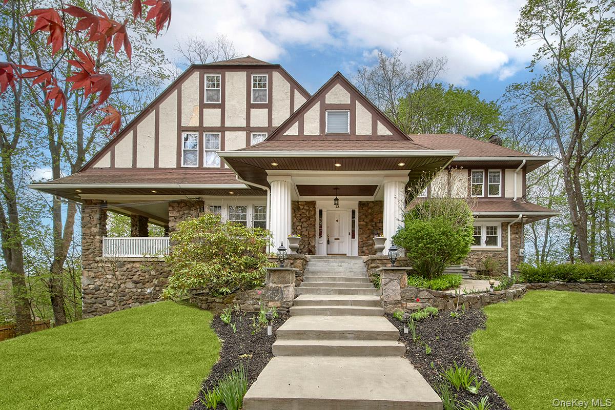Perched gracefully above the road, this stately Tudor evokes a timeles...
