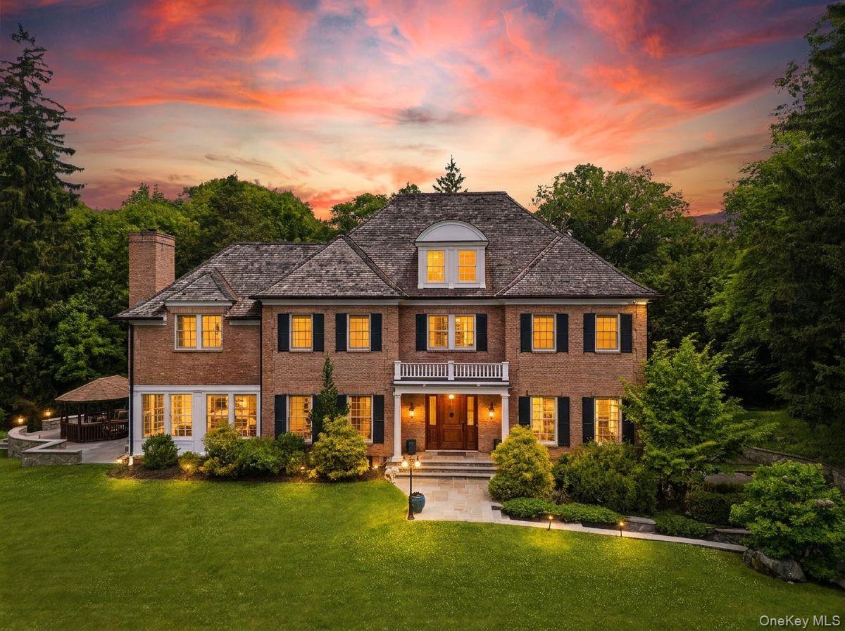 Privately gated and masterfully crafted, this exceptional custom brick...
