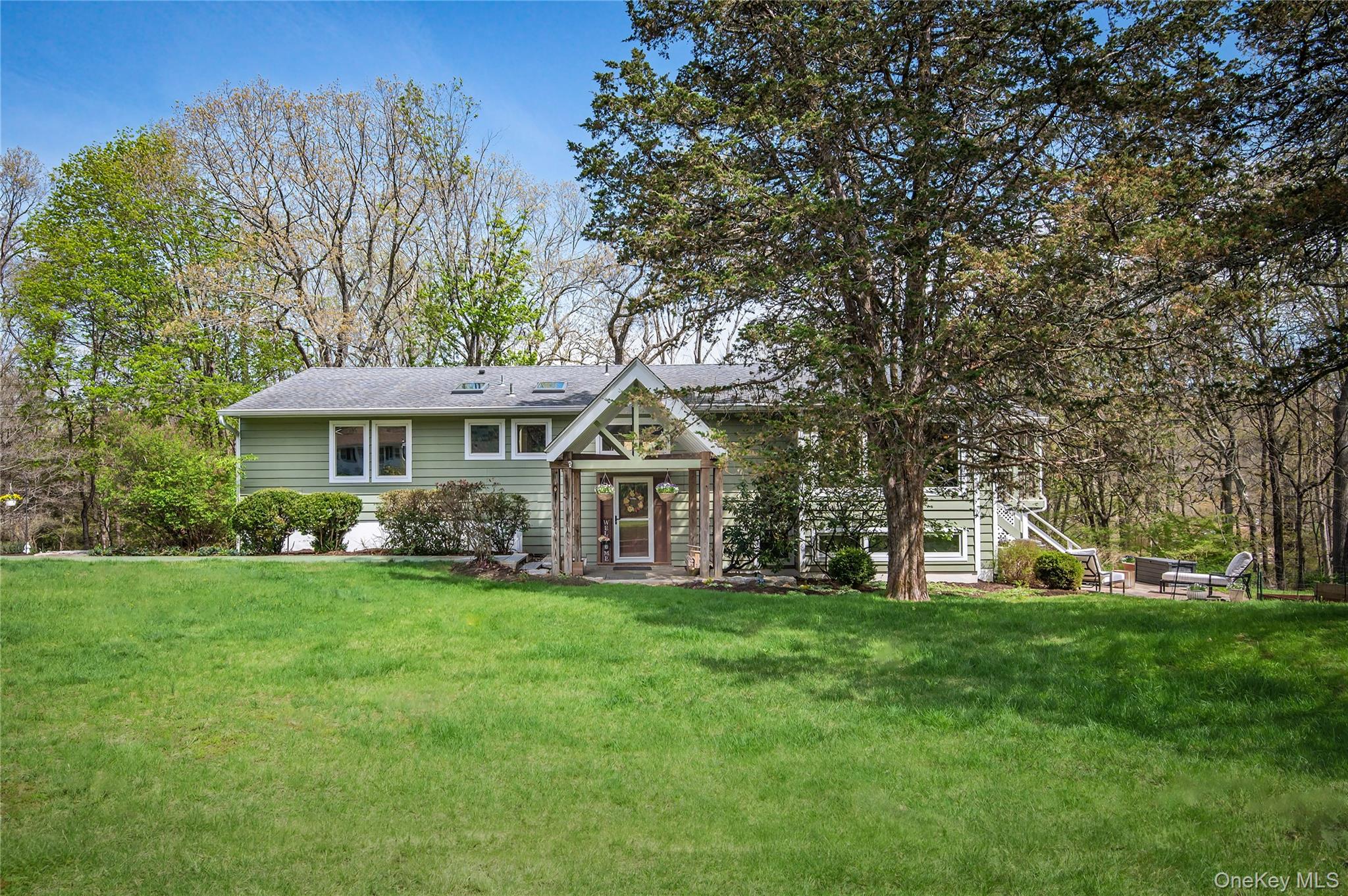 Nestled on a picturesque 1.25-acre setting in sought-after Pound Ridge...