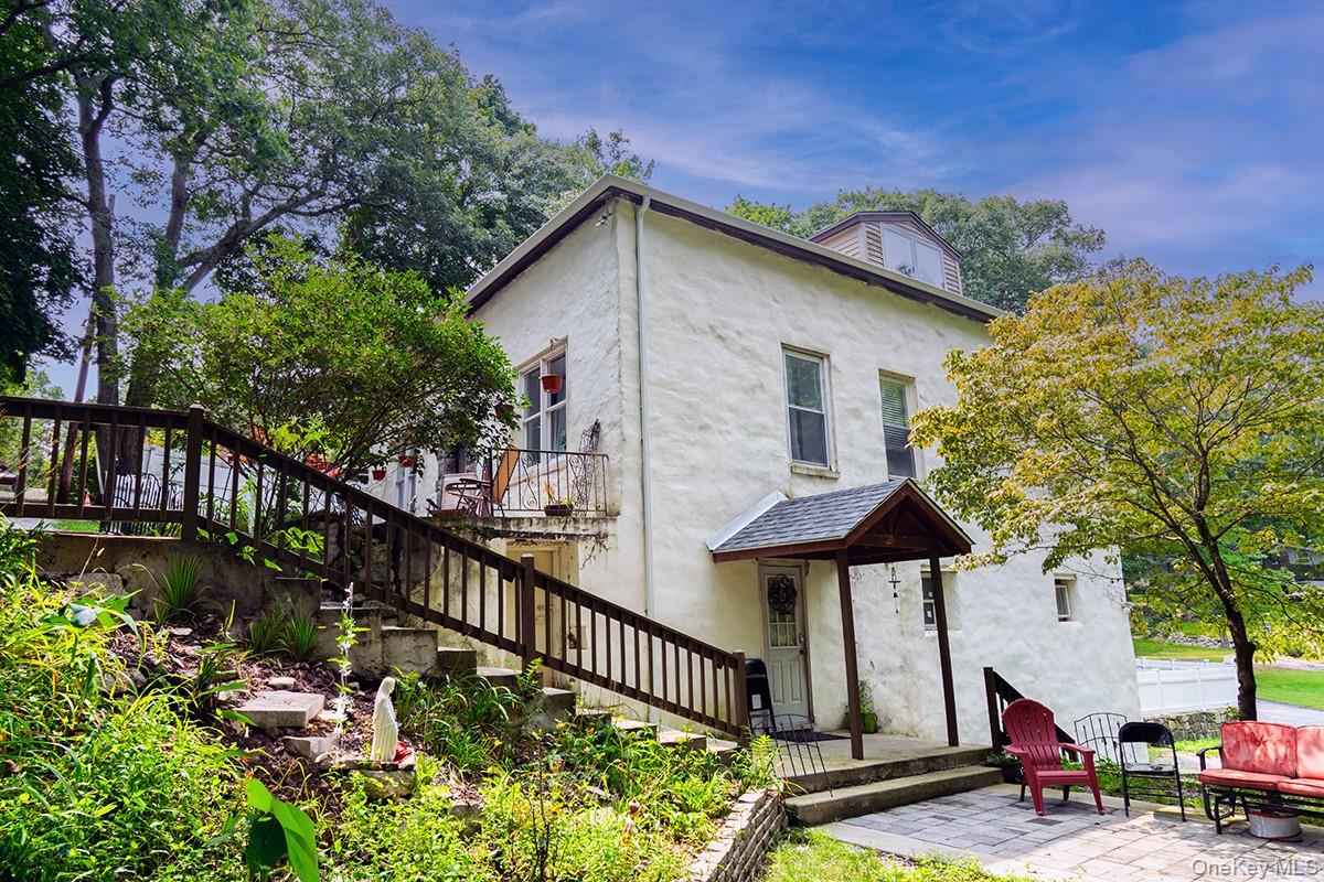 Now featuring a brand new roof and gutters, this distinctive stucco re...